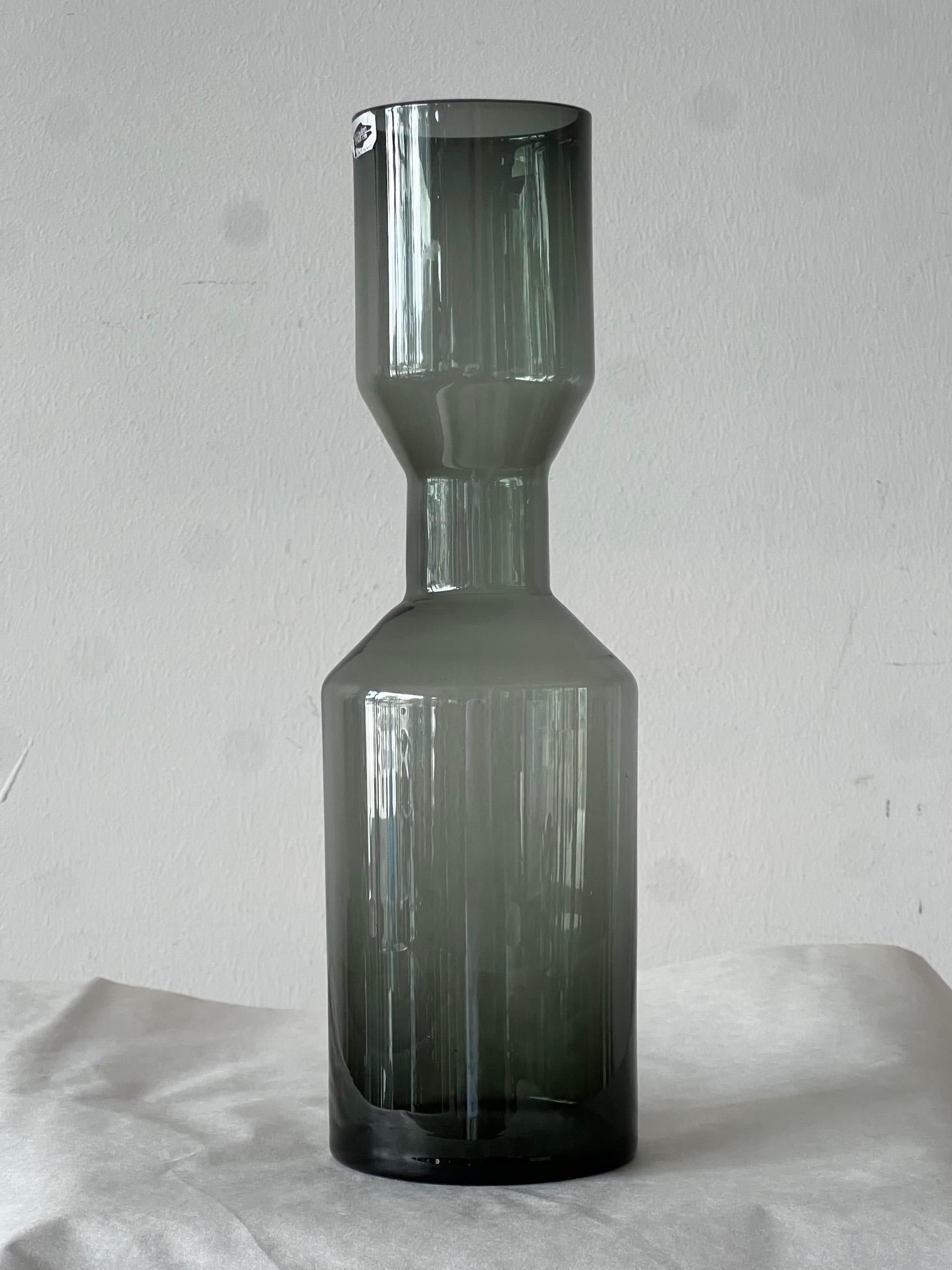 A large and interestingly shaped glass vase by Kaj Franck for Nuutajarvi Notsjo, Finland, ca' 1950's. Smoke glass with original label intact, very good condition.