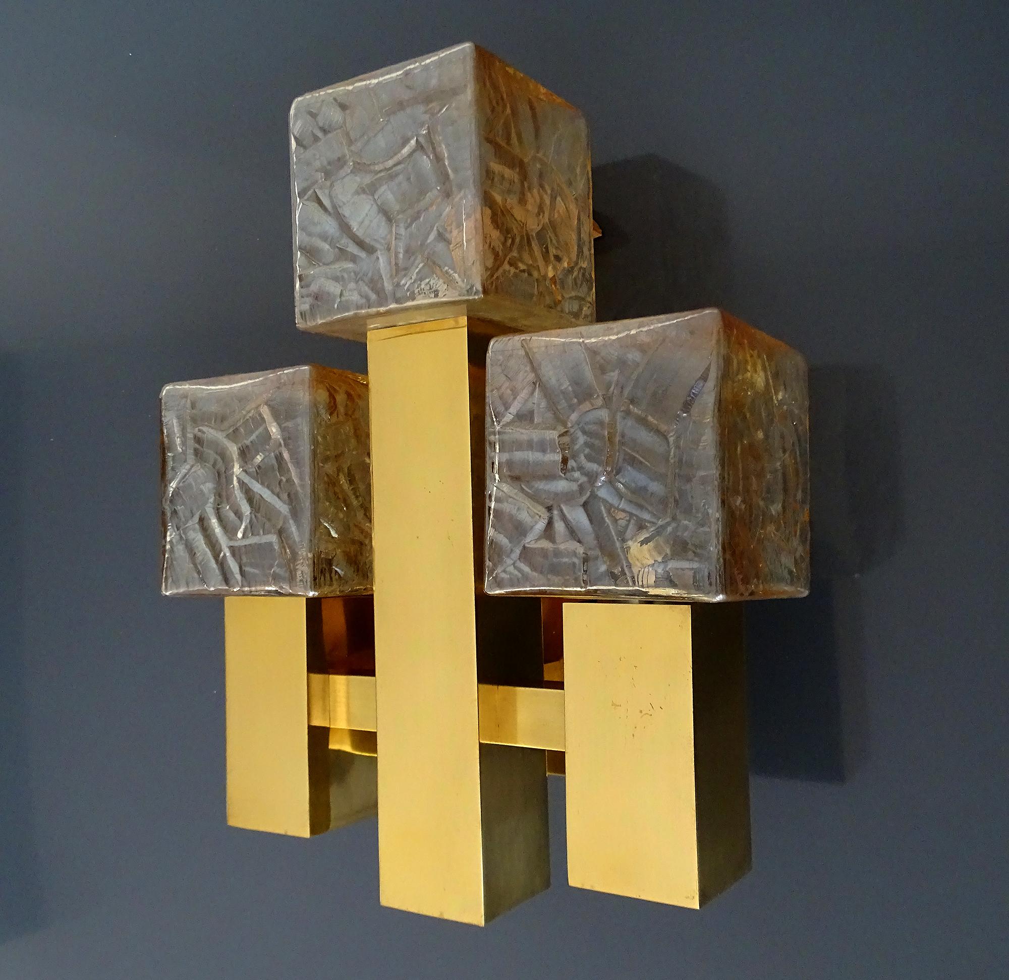 Large Kalmar sconce, featuring 3 structured cubic glass shades with a light amber tint, cruciform brass structure 
Dimensions:
H 14.18 in. x W 11.42 in. x D 5.32 in.
H 36 cm x W 29 cm x D 13.5 cm
Three candelabra size bulbs 40 watts.
