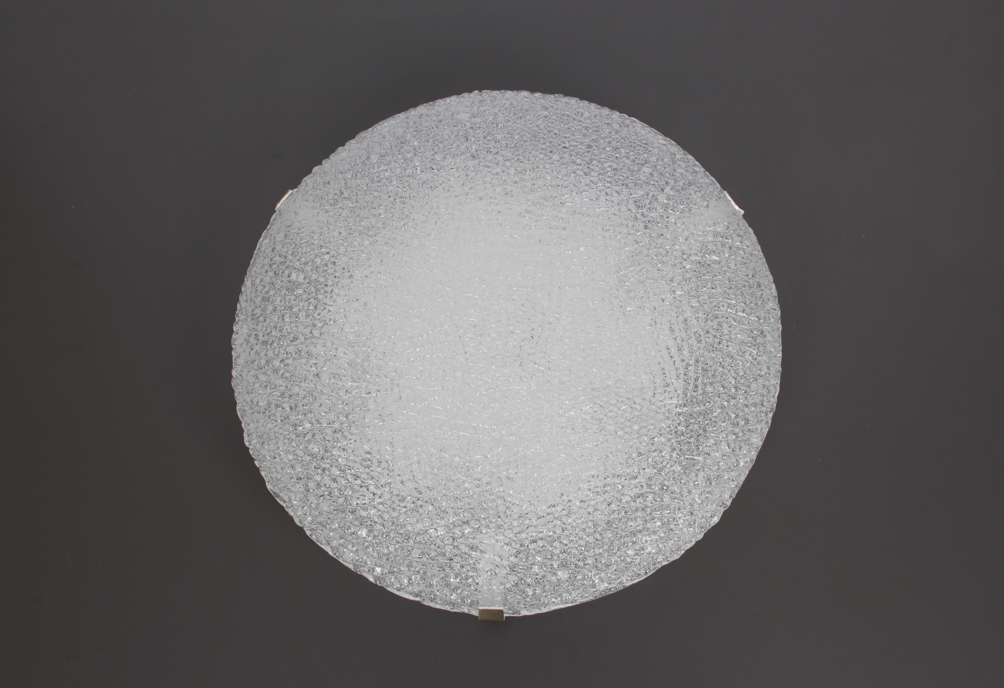 A wonderful round ice glass flush mount, by Kalmar, Austria, 1960s.
Thickly textured Ice glass fixture on a white metal base.

 High quality and in perfect condition. Cleaned, well-wired, and ready to use. 

The fixture requires 6 x E14 Standard