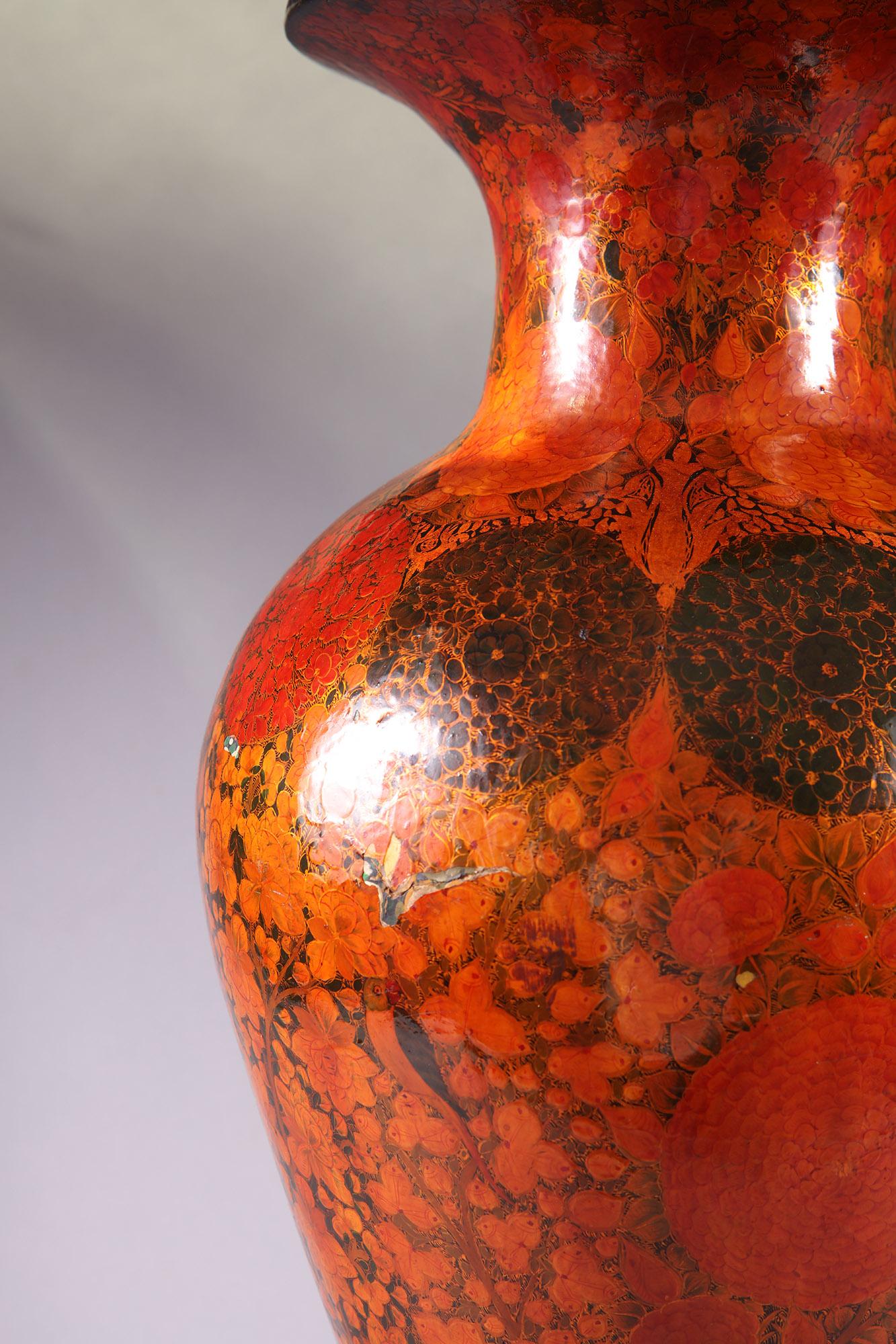 Large Kashmiri vase profusely decorated with flowers on an orange ground, the vase measure 67 cm high and is now mounted as a table lamp. The vase is made of papier-mache 

The shade shown is an example only. 