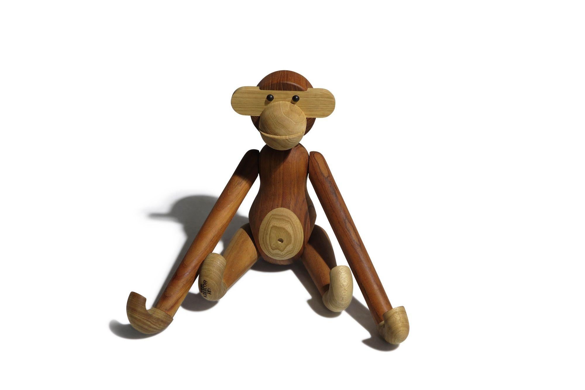Large Kay Bojesen monkey, designed in 1951, Denmark. Sculpted of solid teak and limba wood. It features segmented limbs, movable heads, arms and legs. Stamped.

Measurements: Body 18