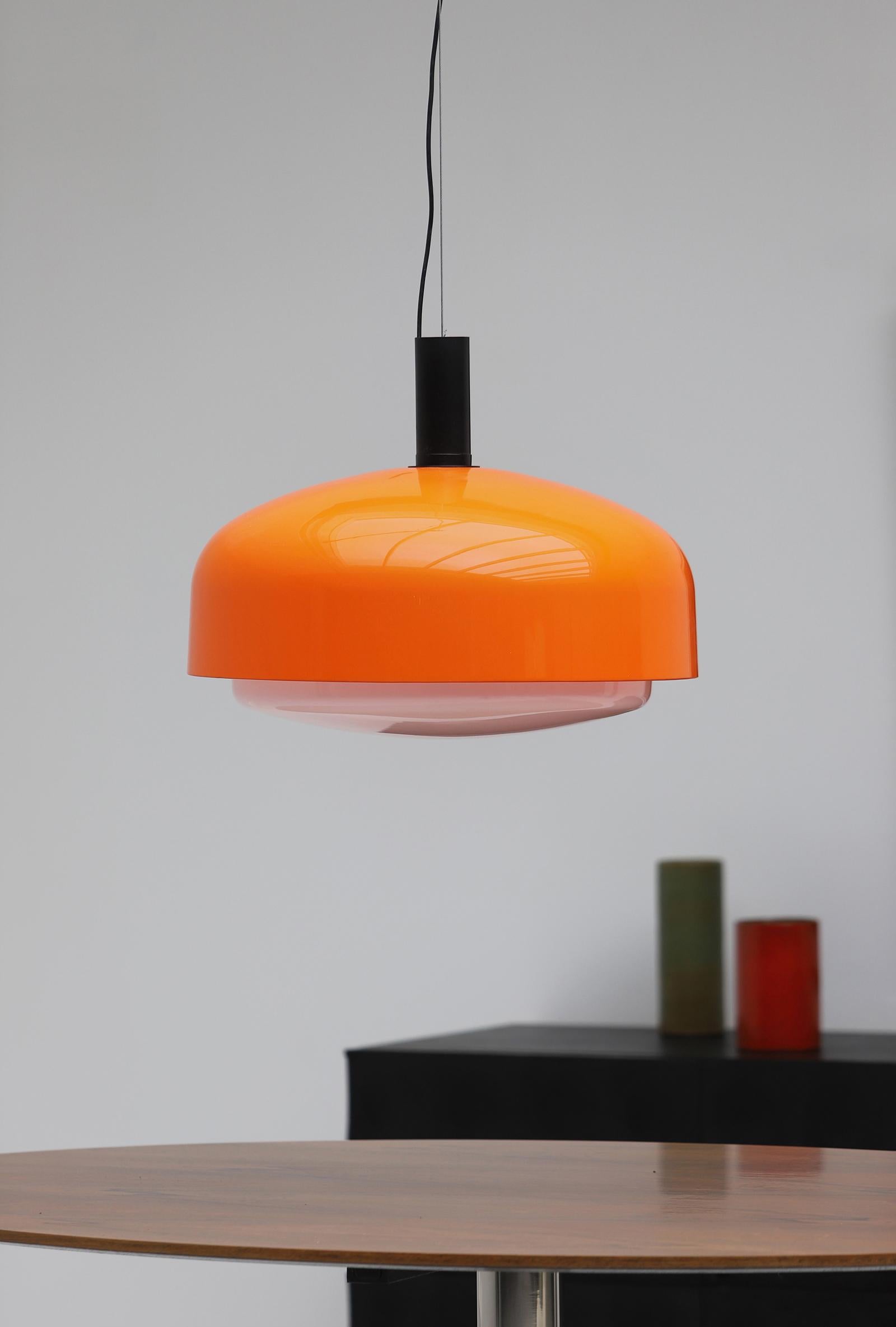 Grande lampe en attente d'Eugenio Gentili Tedeschi modèle KD 62 conçue pour Kartell en 1965. La lampe est dotée d'un abat-jour orange et blanc en acrylique et est finie avec des détails en métal. Cette grande lampe suspendue est en très bon état,