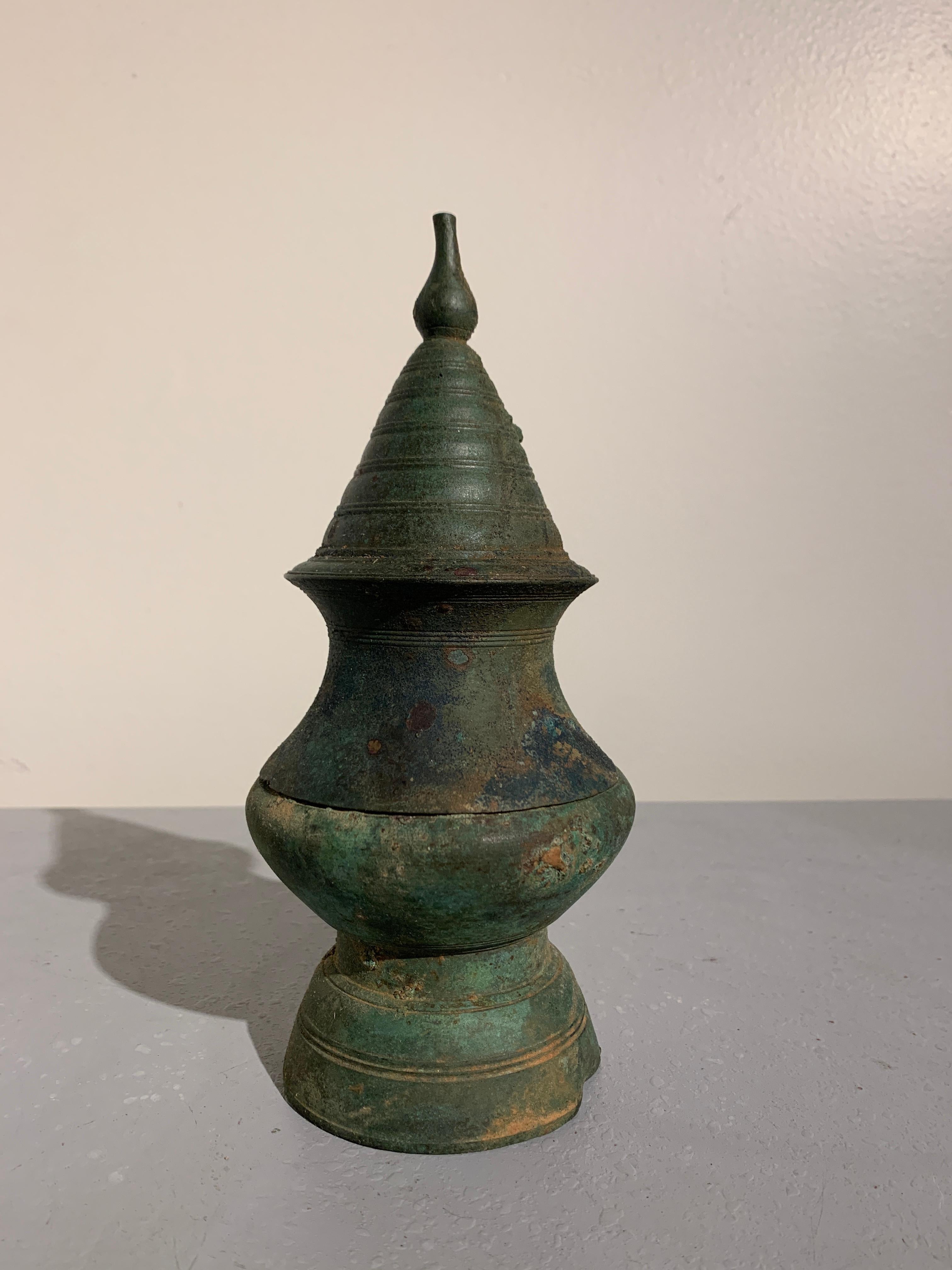 An unusually large Khmer bronze lime pot in the form of a stupa, Angkor Period, 12th-14th century,

The vessel, used to hold slaked lime (calcium hydroxide) powder, an essential ingredient used in the ritual chewing of betel, is cast in two parts.