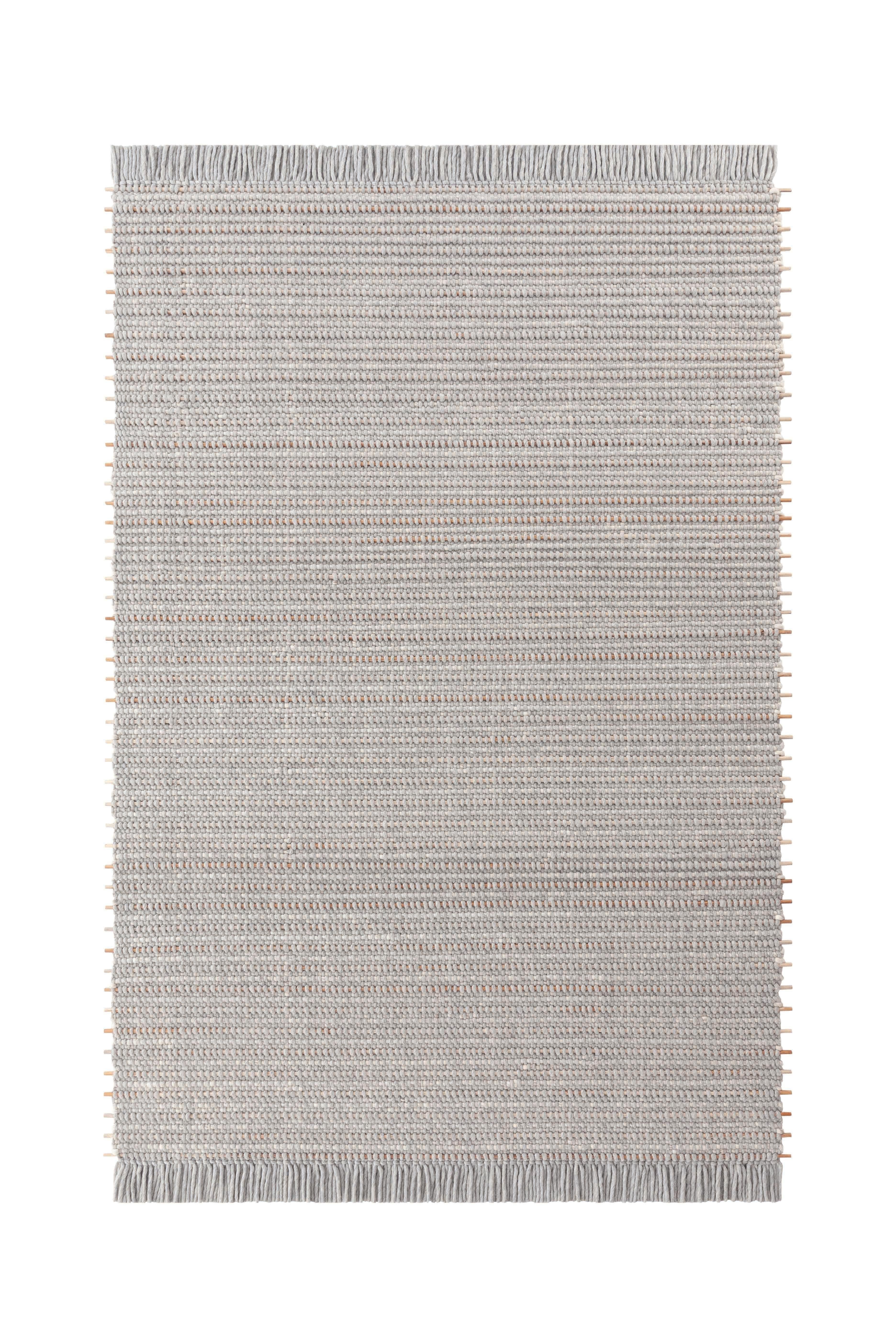 Large Kiri Light Grey Goz Rug by Gandia Blasco
Design by Kengo Kuma
Dimensions: W 206 x H 300 cm. 
Materials: Wool, teak wood. 
Weight: 25 kg

Passion for life outdoors, a dream come true on the edge of a cliff in the north of Ibiza. The elemental