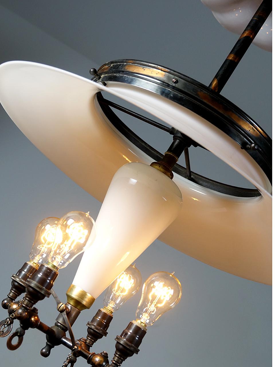 This is a lamp that you would have found hanging in an early Pharmacy. They have great detail including a large 20 inch tented milk glass shade and brass crown. The central milk glass cone reflector is its most unique feature that is found only on