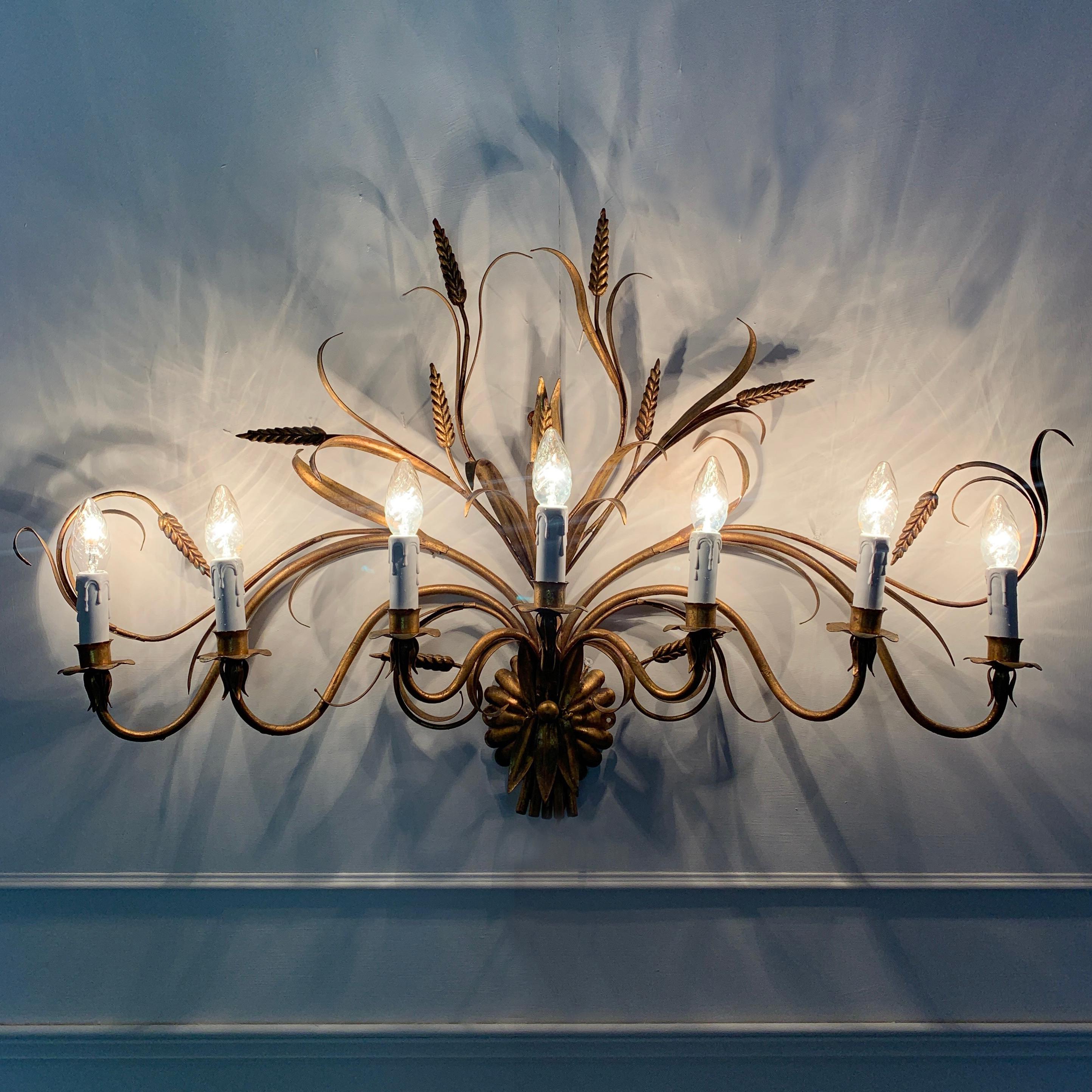 Large Hans Kögl wheat sheaf and leaves wall sconce
1970s Hans Kögl, Belgium

This very large and beautiful wall sconce is a real statement piece
There are 7 handcrafted curved gilt stems, decorated fully with gilt leaves and wheat sheaf