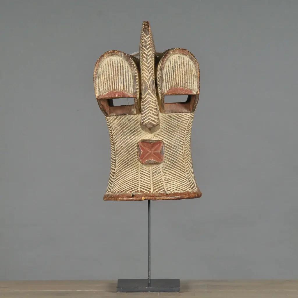 This Kongo tribal mask is a finely handcrafted decorative piece inspired by the traditional art of the Songhe tribes from Central Africa. Made from hand-carved wood and adorned with natural pigments, the mask reflects the rich symbolism and cultural