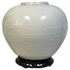 Large Korean Monochrome Porcelain Moon Jar on Carved Wood Stand, 20th Century