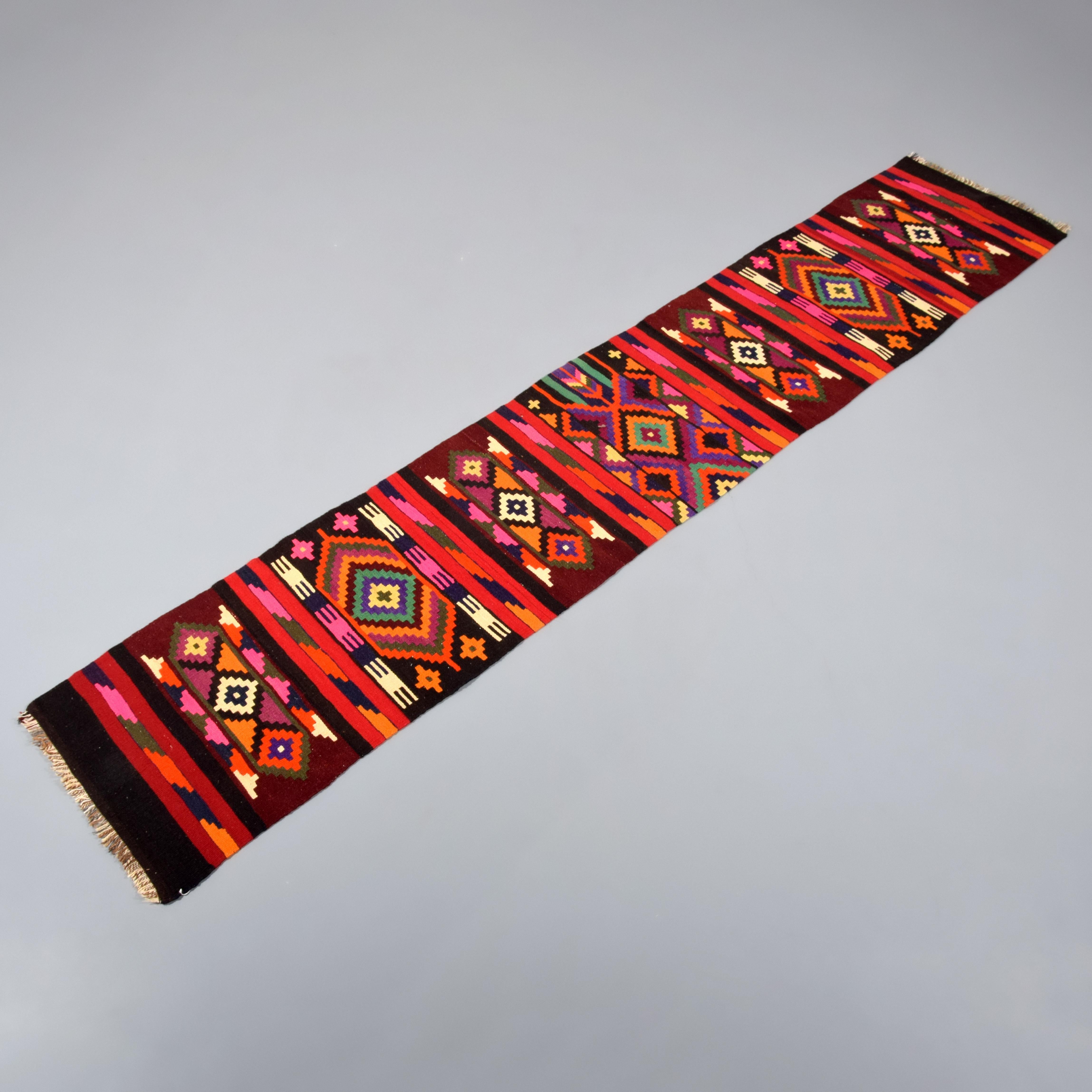 Additional Information: Kurdish village runner made for home use, a rare find in the big city bazaars. Flat woven rug has traditional, local bold patterns and colors. Kurdish people use bright colors like pink and orange to ward off the Evil Eye.