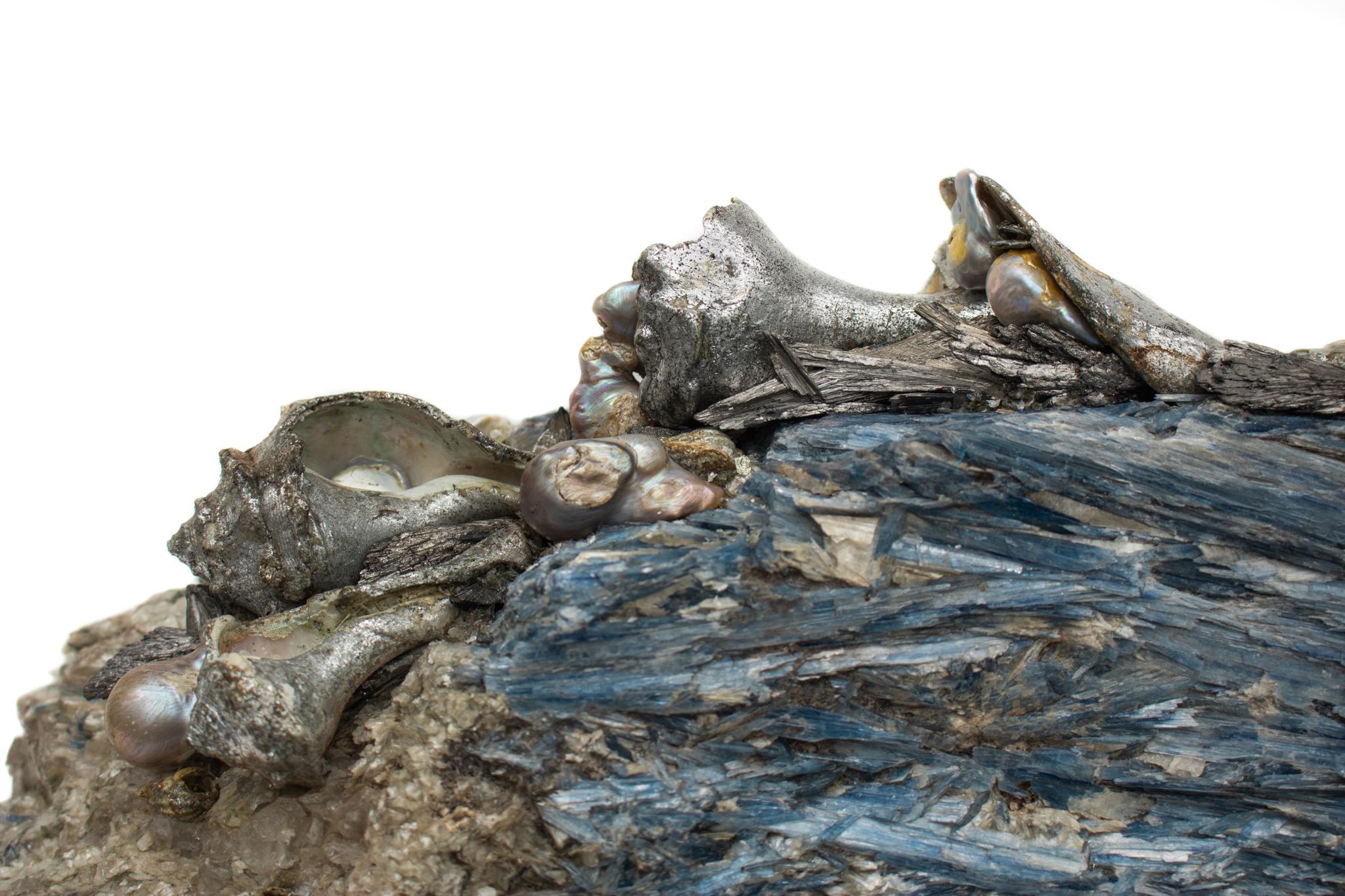 Kyanite adorned with silver leaf shells, silver plated kyanite, and natural-forming baroque pearls. This is one of the largest forms of kyanite found. It is incredibly rare and almost impossible to find a piece in this particular size. The specimen