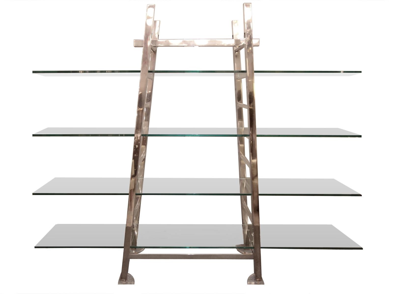 Structure in chromed metal and Plexiglas, shelves of clear glass.
A lighting lamp is hidden in the upper central bar, to illuminate the objects on the shelves.

Measures: Height 6 ft0 3.19 in
Width 7 ft. 6.55 in. The shelves can be reduced