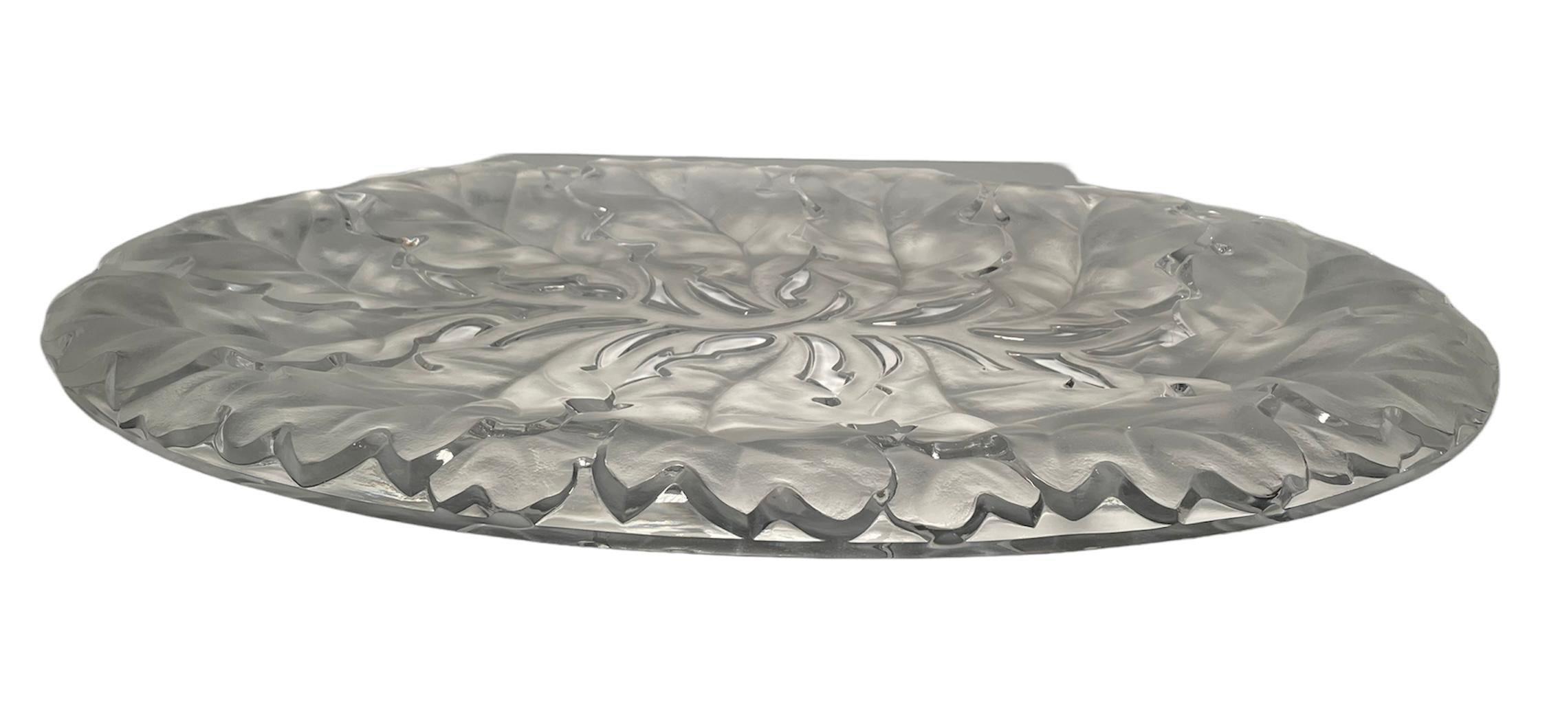 This is a Lalique crystal “Chene” oak leaves platter. It depicts a clear and frosted large oval heavy crystal tray/plate with a relief of a long branch full of big oak leaves. Below the base, it is hallmarked Lalique encircled R,France.