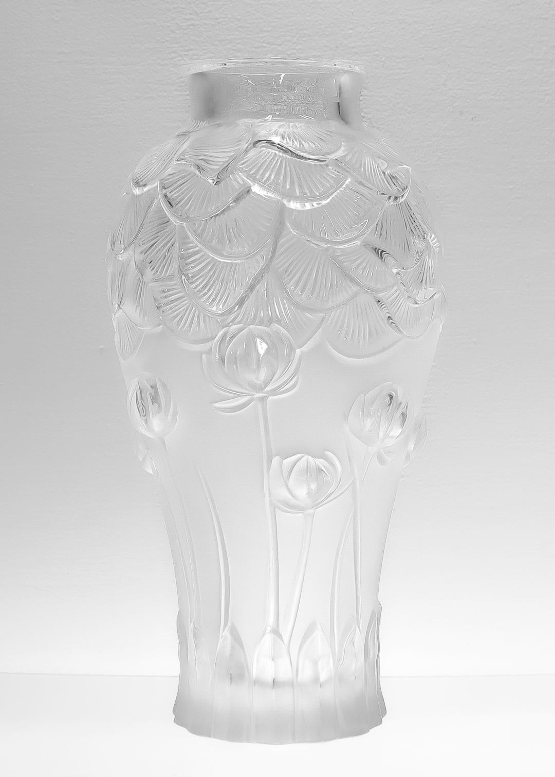 A fine, large Lalique glass or crystal flower vase.

In the Giverny pattern.

Model no. 1250000

In frosted Lalique glass with stylized water lily flowers and leaves around the circumference, transparent highlights, and a transparent rim.

Bearing