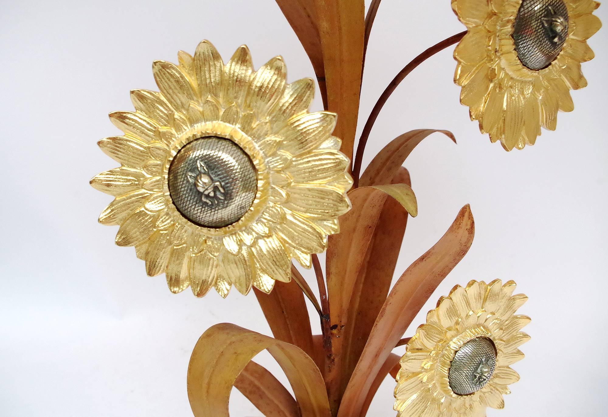 Large lamp in gilt brass and gilt bronze standing on a square base and topped by three sunflowers.
French work form the 1970s.
Refurbished and functional electrical system.
 
