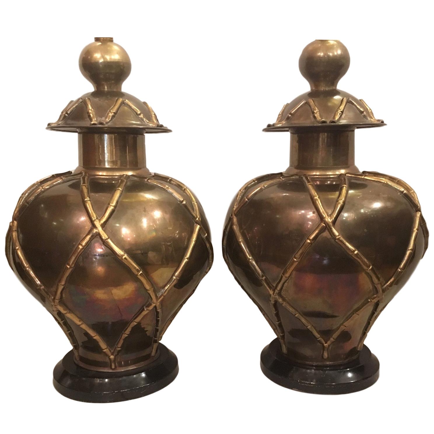 Pair of large circa 1940's French brass table lamps with hammered bamboo pattern on body, original patina and wooden bases.

Measurements:
Height of body: 23