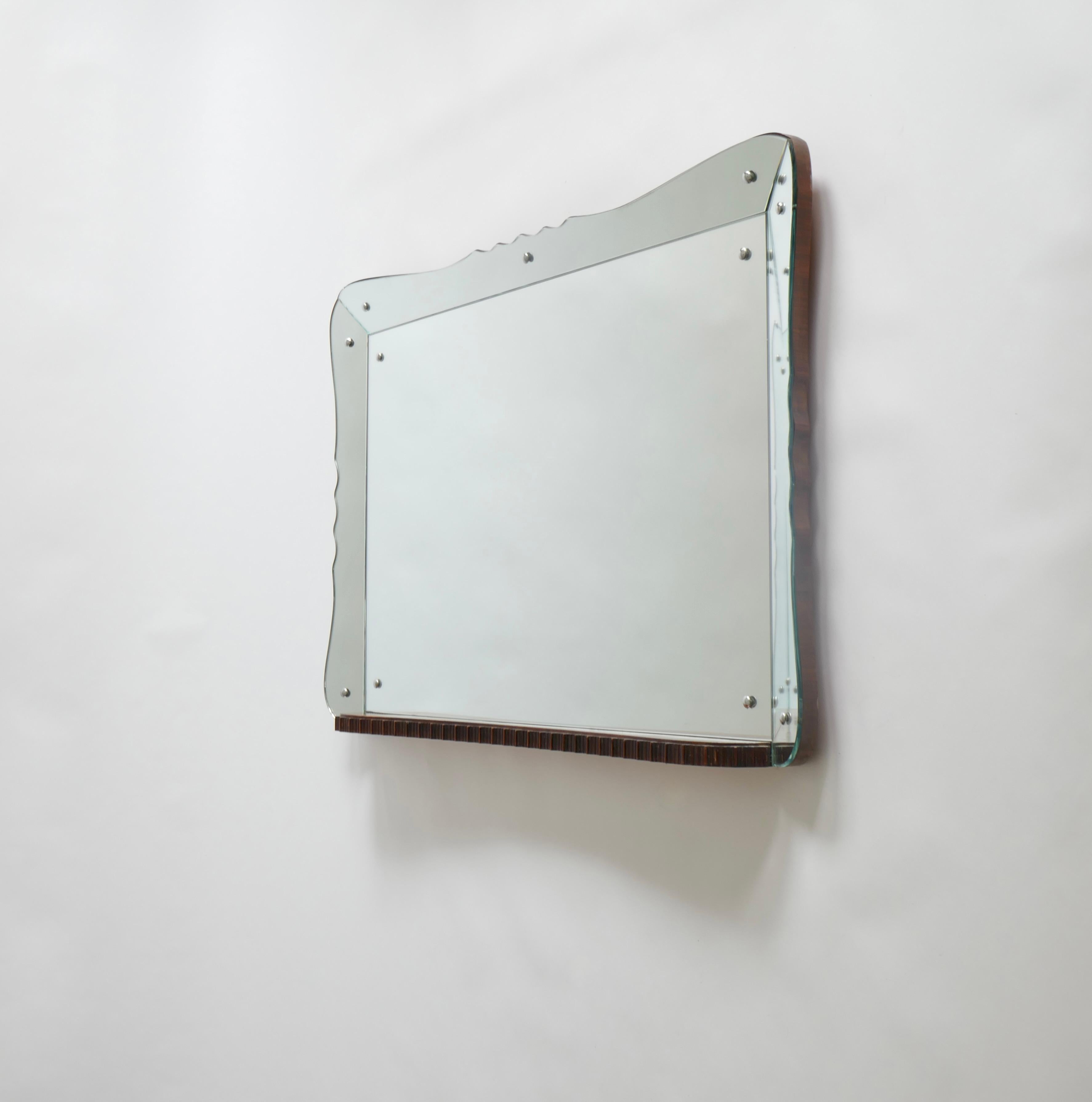 A unique large landscape mirror with a curved angled tray mirror frame. A delicate scallop pattern runs in the centre of the 3 sides of the mirror.
The beautiful wood back panel protrudes at the bottom - which is straight - into a tablet. The