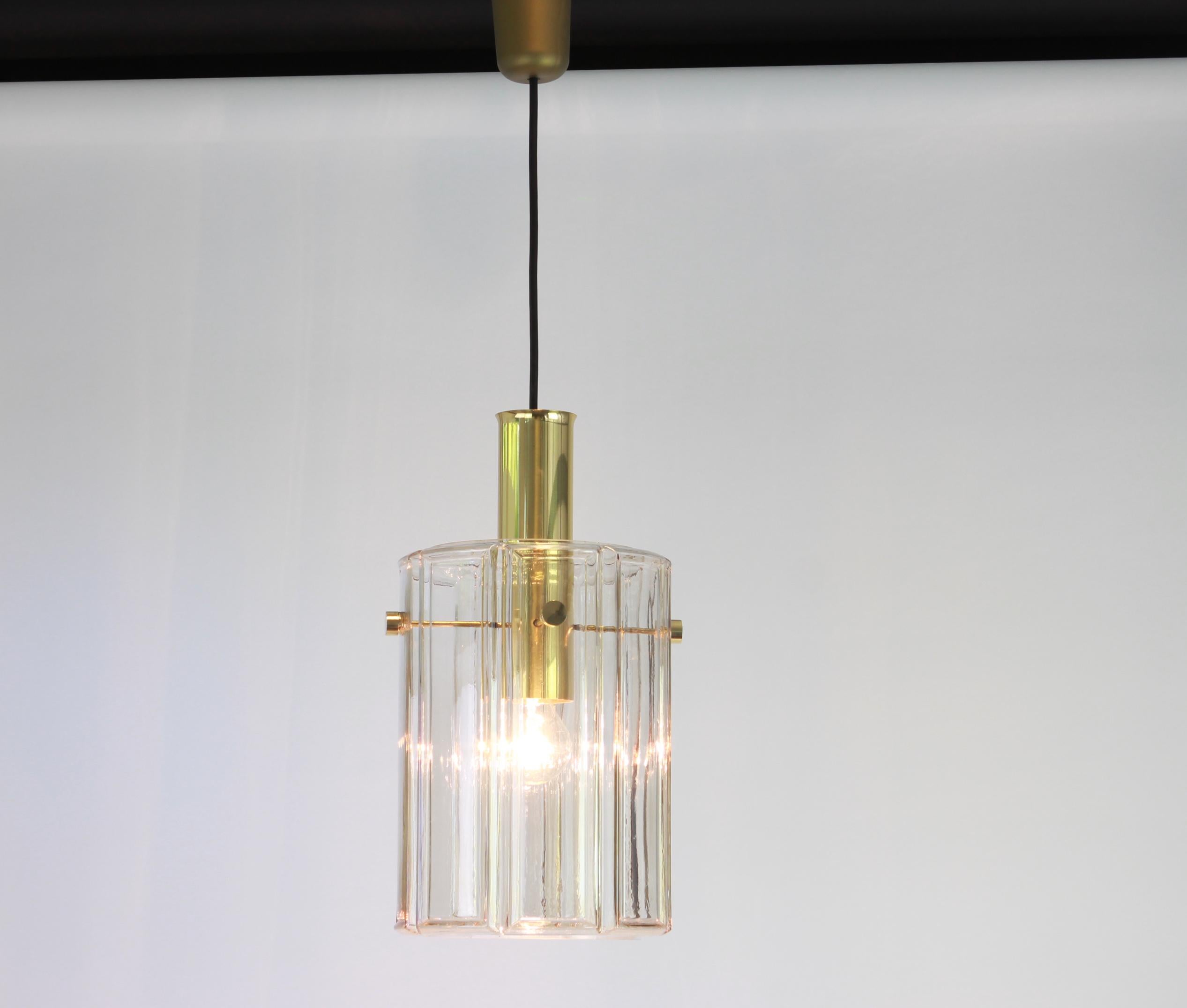 Brass pendant fixture with cylindrical glass shade design by Limburg, Germany, 1960s

Heavy quality and in very good condition. Cleaned, well-wired and ready to use. The fixture requires 1 x E27 Standard bulbs with 100W max each and function on a