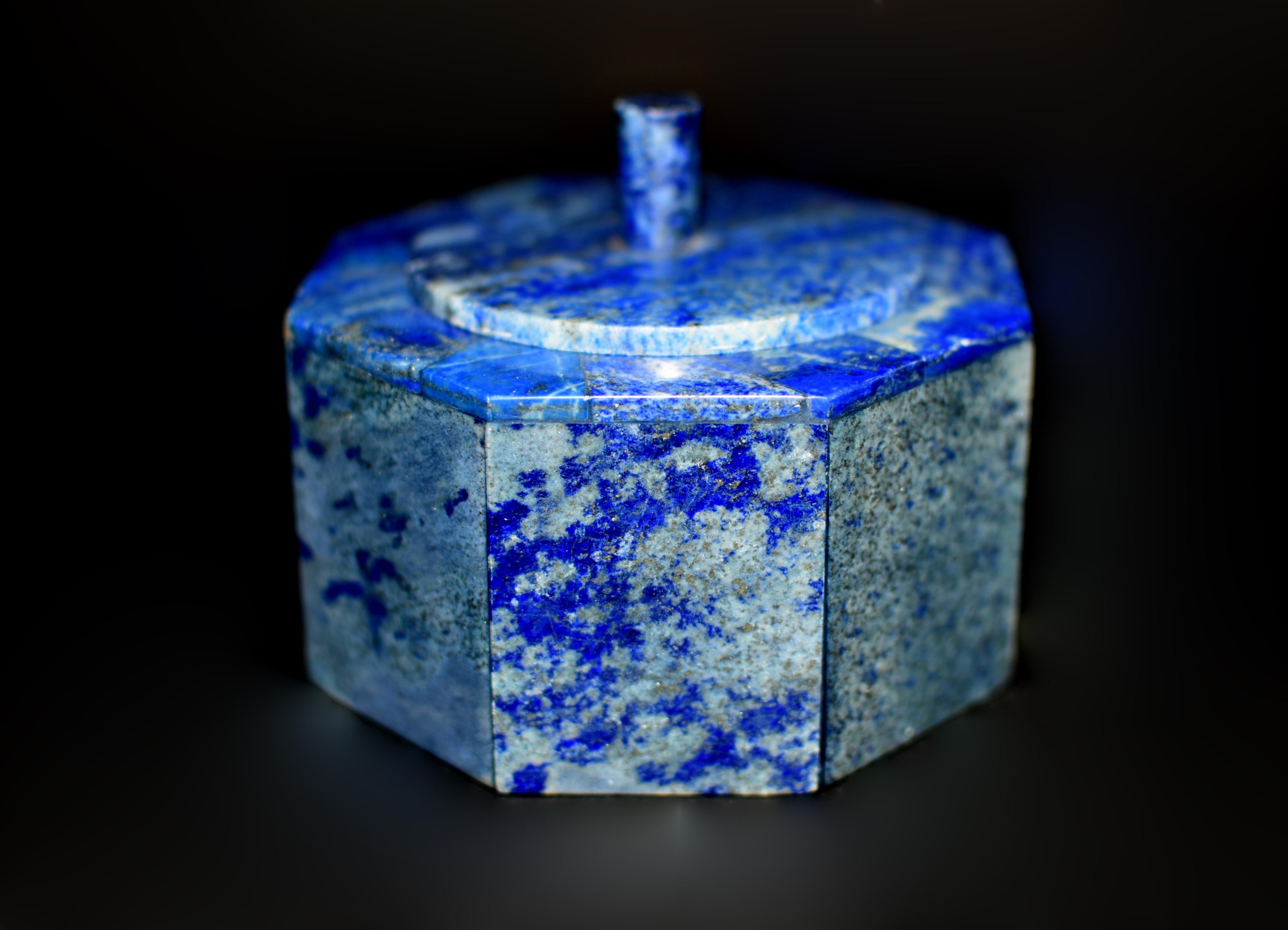 Beautiful 1.1 lb hexagonal box made of the fine natural lapis lazuli from Afghanistan. A round lid with elegant finial and fine carrara marble interior. Stunning blue color with gold dust pyrite enhancing the beauty of the gemstone. Finely crafted