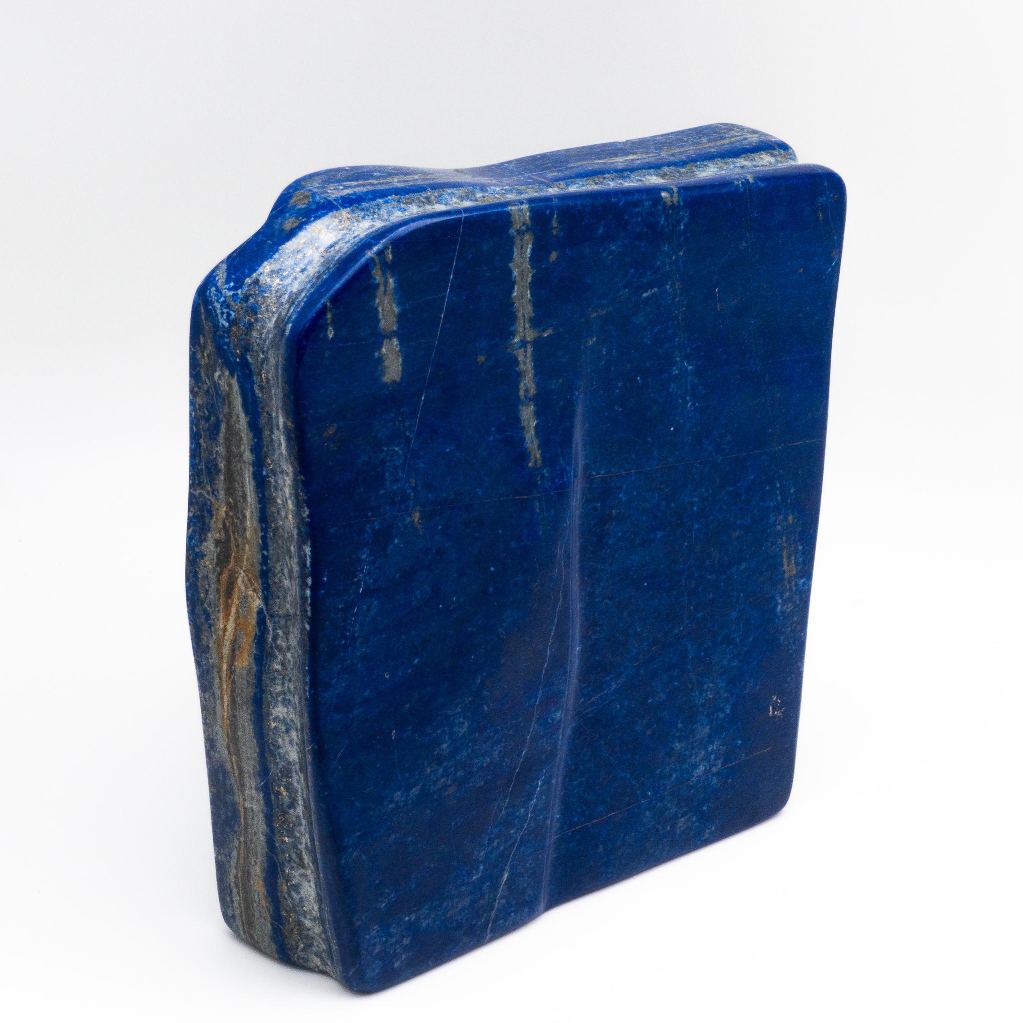 Beautifully polished lapis lazuli mineral specimen from Afghanistan. This semi-precious stone has been prized since antiquity due to its intense, beautiful blue coloring and golden speckles. It was also used in the fine arts, in a crushed powder