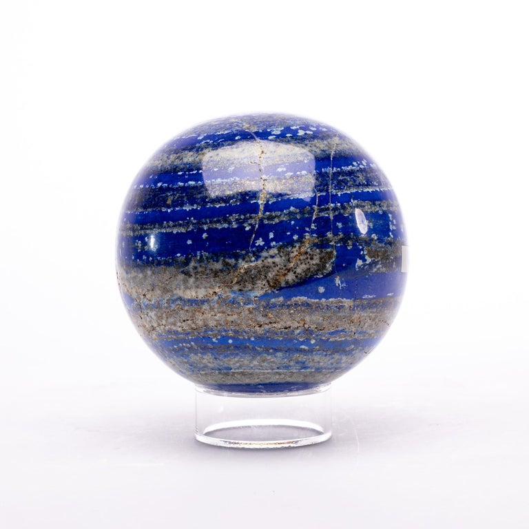 This beautiful large lapis lazuli sphere from Afghanistan features outstanding hues of blue, gold, and white.