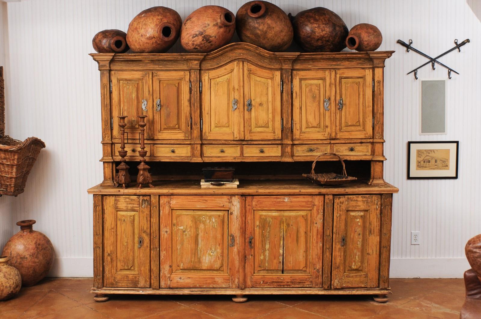 A large late 18th century French buffet à deux-corps in fir wood from a monastery near Avignon. Created in Southern France during the last decade of the 18th century, this buffet à deux-corps attracts our attention with its wonderfully weathered