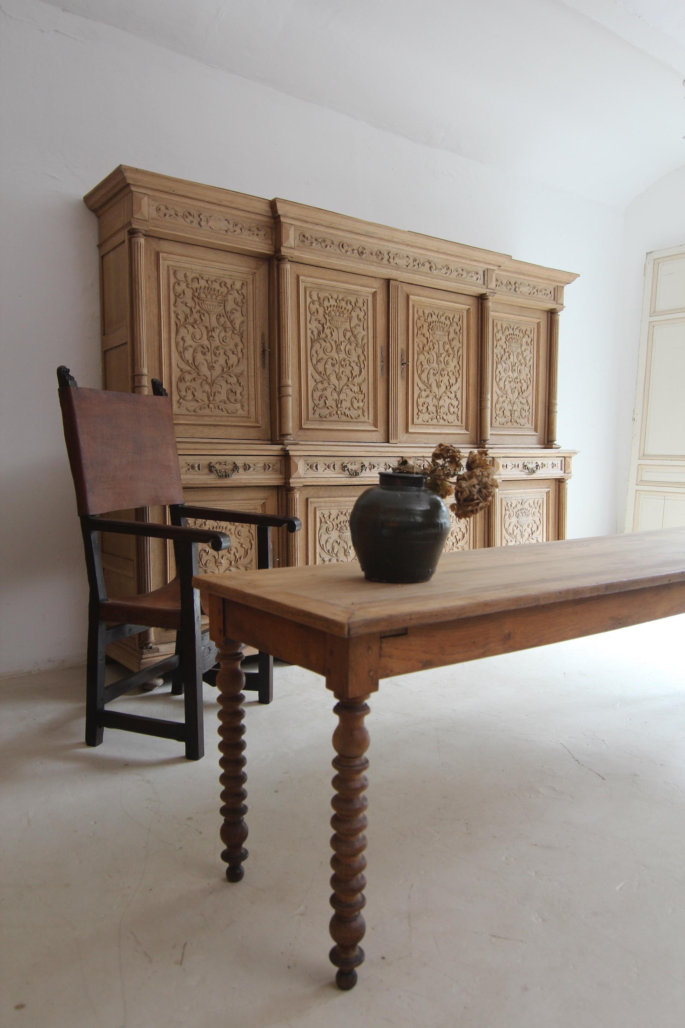Exceptionally large buffet cabinet from the late 19th century. Solidly crafted in oak with bleached surface.

Two-piece side-coffered oak body with 8 doors and 4 drawers, standing on 8 feet. The front with a central risalit is symmetrically divided