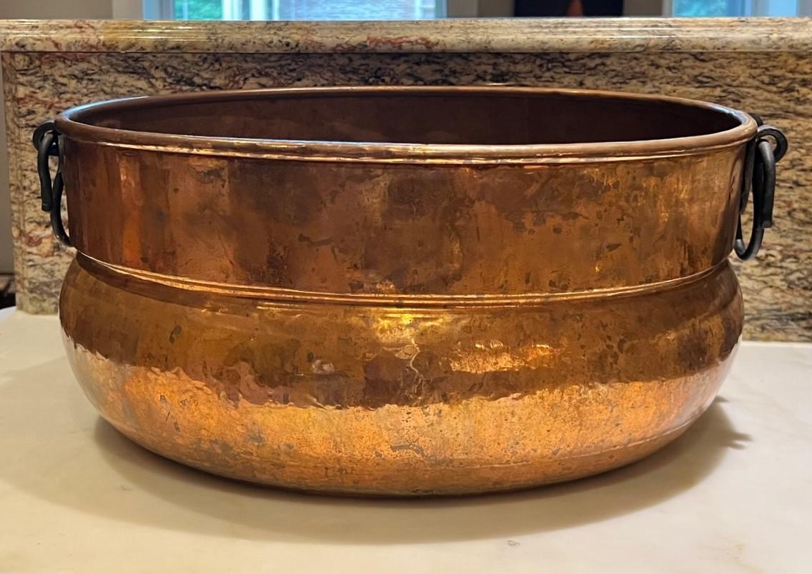 Late 19th C. large copper jardiniere with rolled rim and snake form wrought iron handles. This pot has acquired a lovely patina with some interior oxidation. Despite its age, the pot remains watertight. Made with evident craftsmanship, the brazed