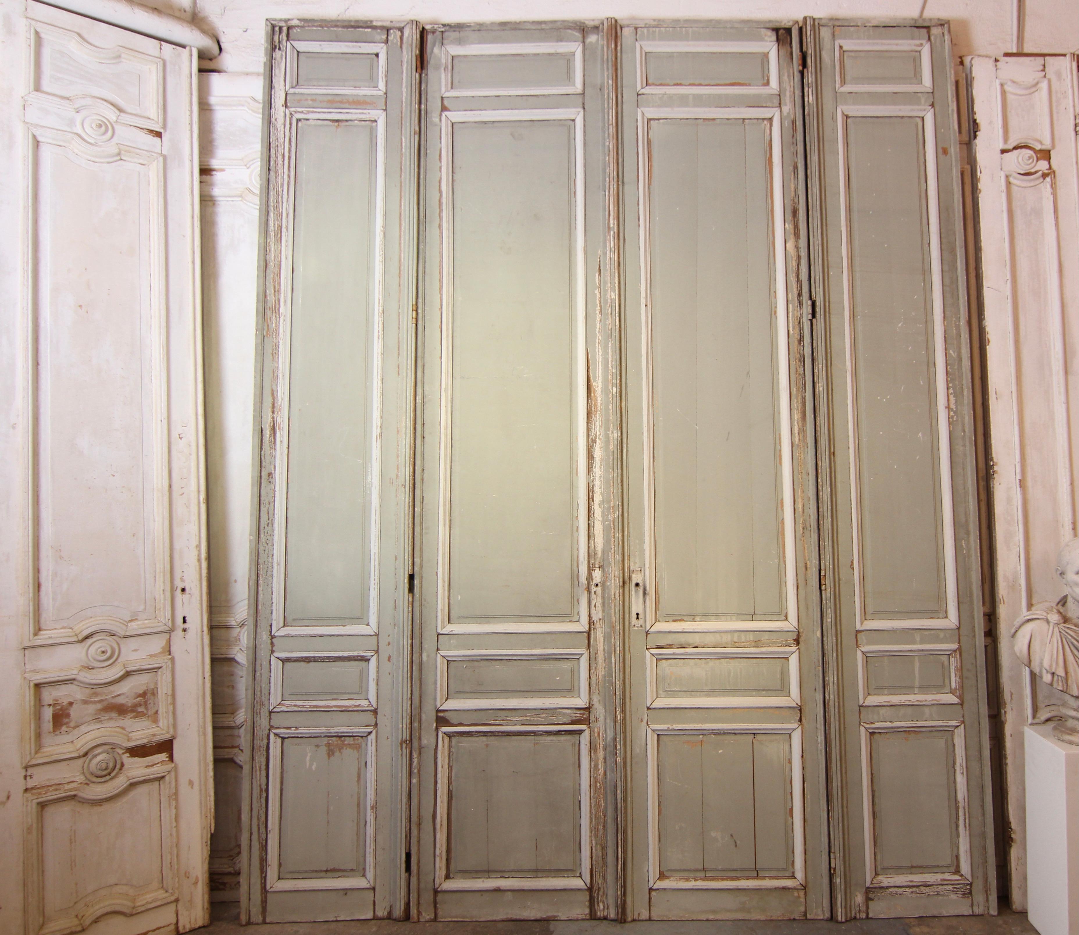 Large French double door from the late 19th century. Made of solid pine wood in the original paint.

Doors made in frame construction with 4 cassettes each.

Very beautiful original patina.

Set consisting of a double door flanked by 2 side
