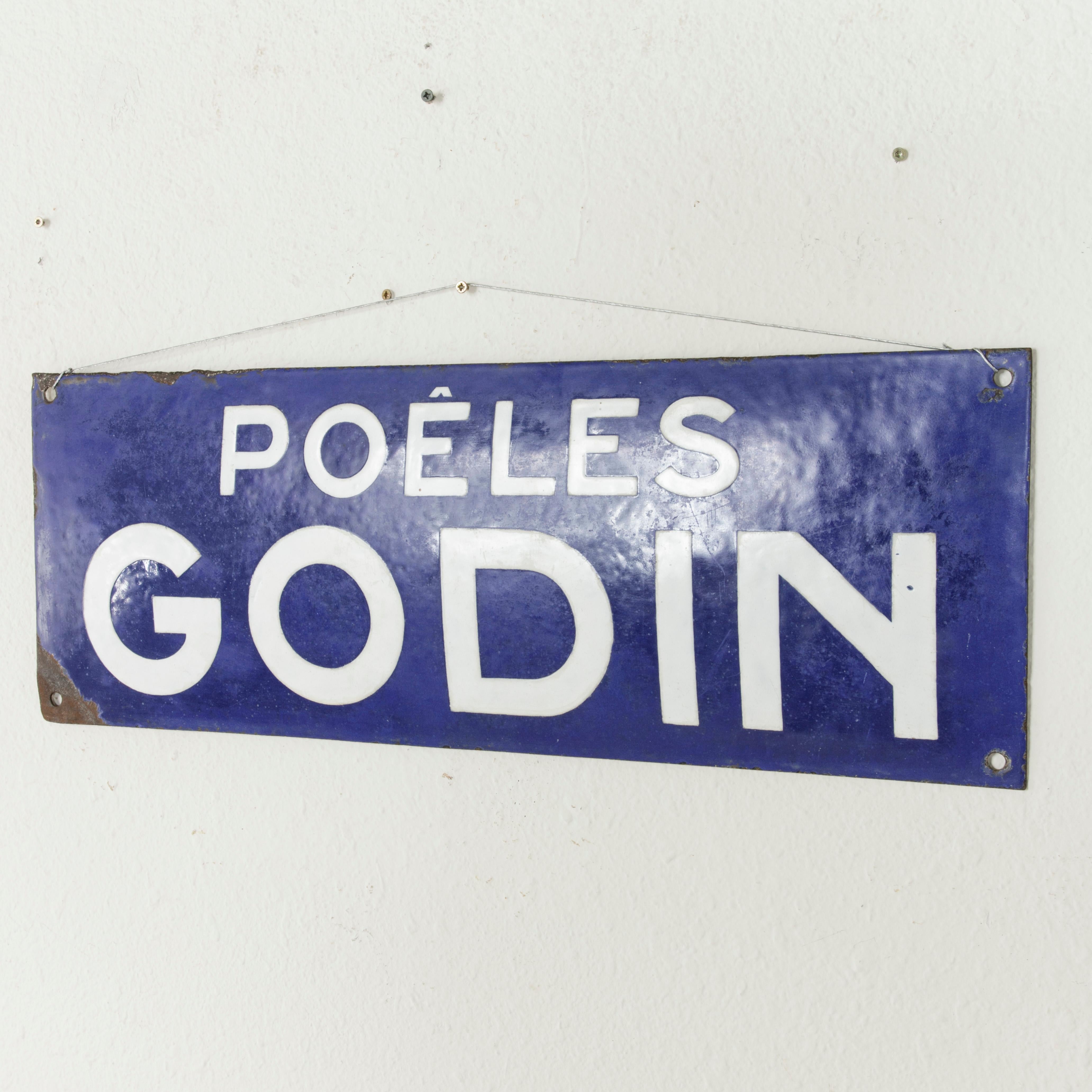 This late 19th century French blue and white enameled bombe sign or plaque features the name Poeles Godin advertising Godin Stoves. The manufacturing of Godin stoves began in 1840 by the French industrialist Jean-Baptiste Andre Godin (1817-1888),