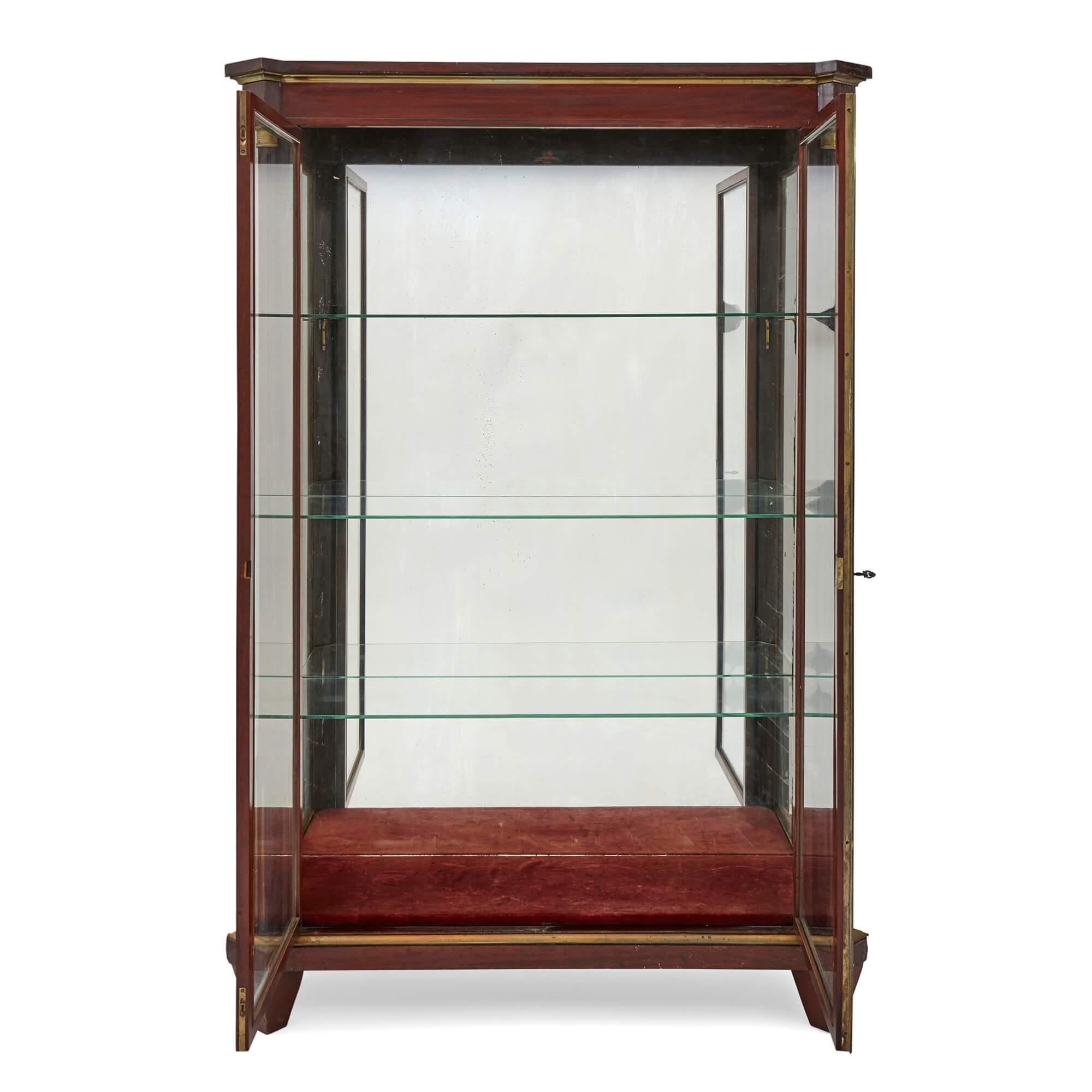 Large late 19th century french neoclassical gilt metal mounted vitrine
Measures: Height 184cm, width 121cm, depth 46cm

This excellent display cabinet is a large late nineteenth century vitrine, made in France, and features gilt metallic elements