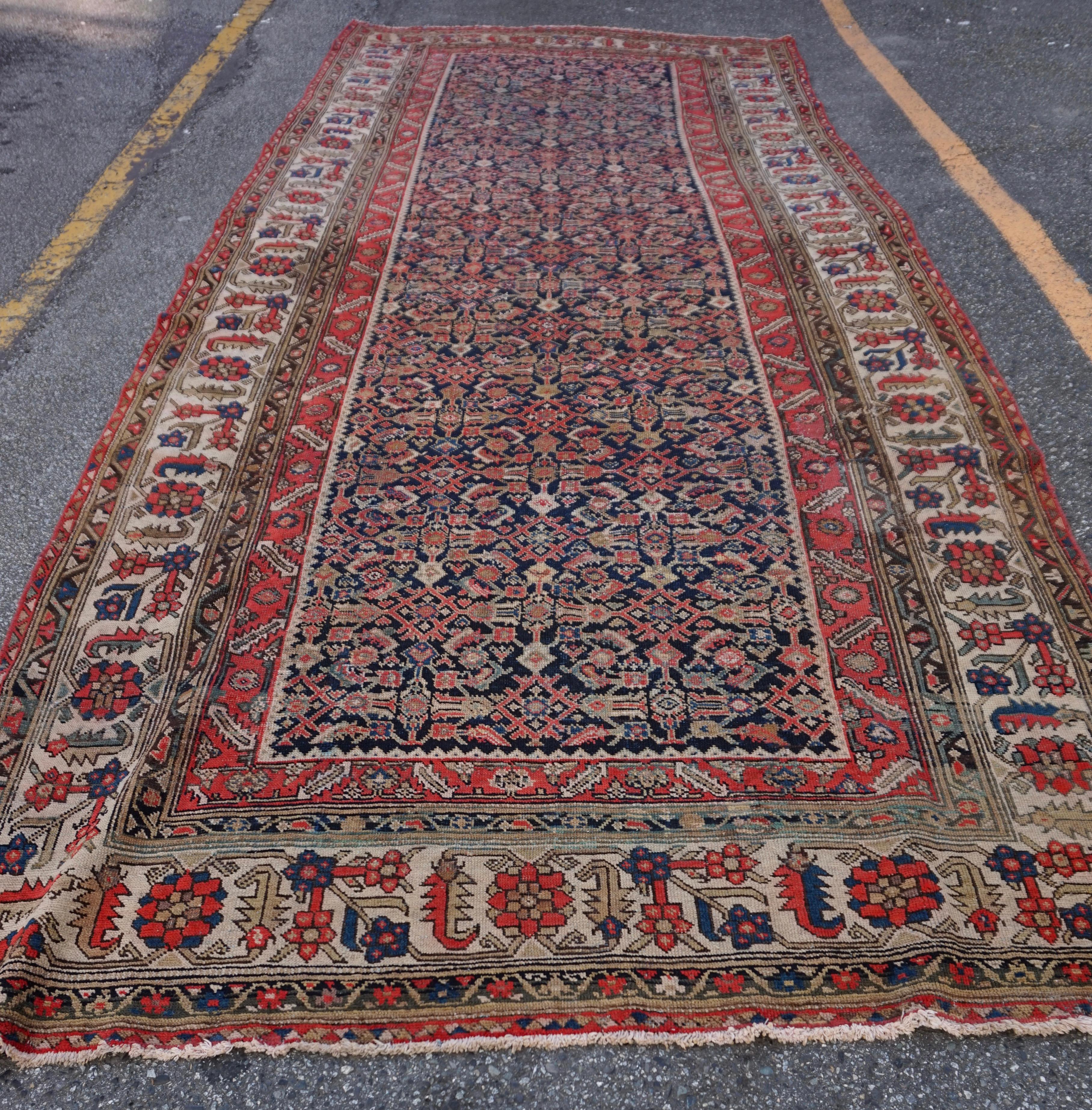 Circa 1890-1900

Herati design North West Kurdish Rug hand knotted in beautiful matted hues. Likely custom woven for a stately hallway or foyer. Intact and in good overall condition with minor repair. Sturdy with excellent character and life left to