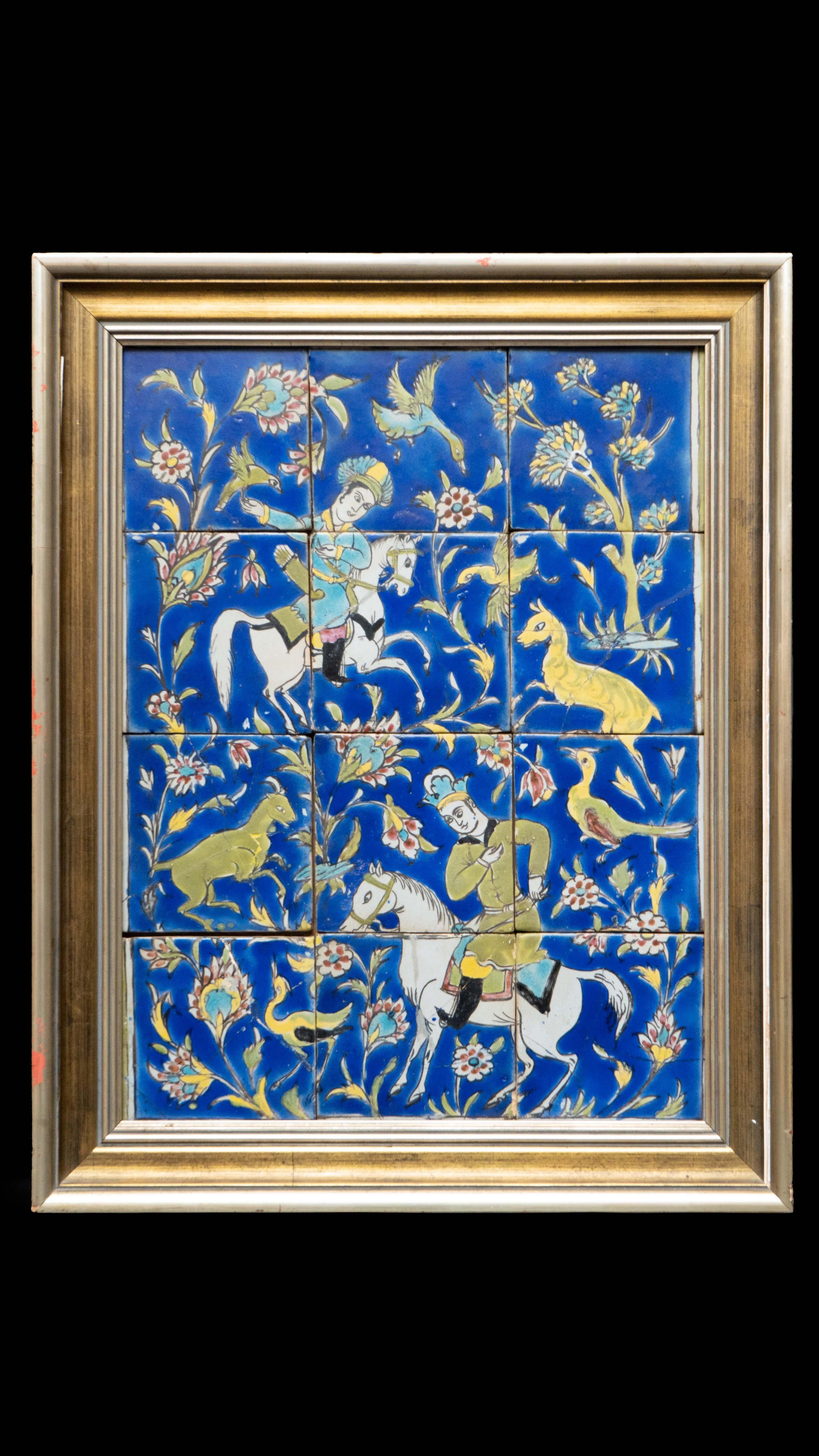 Large late 19th century hand painted Persian tile framed panel. Siliceous paste painted in polychromy under transparent colorless glaze. This panel represents a hunting scene on a cobalt background. The two characters, including a falconer, are