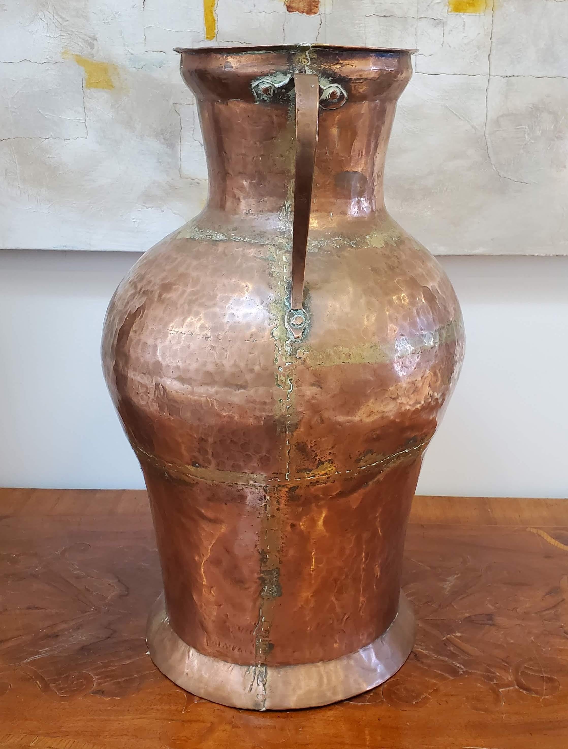 Large 19th century copper urn. Good old patinated surface. Great proportions With two handles and hand hammered surface. Wonderful craftsmanship. 
North Africa, circa 1870
Measures: 21” H, 12” Dia
 
