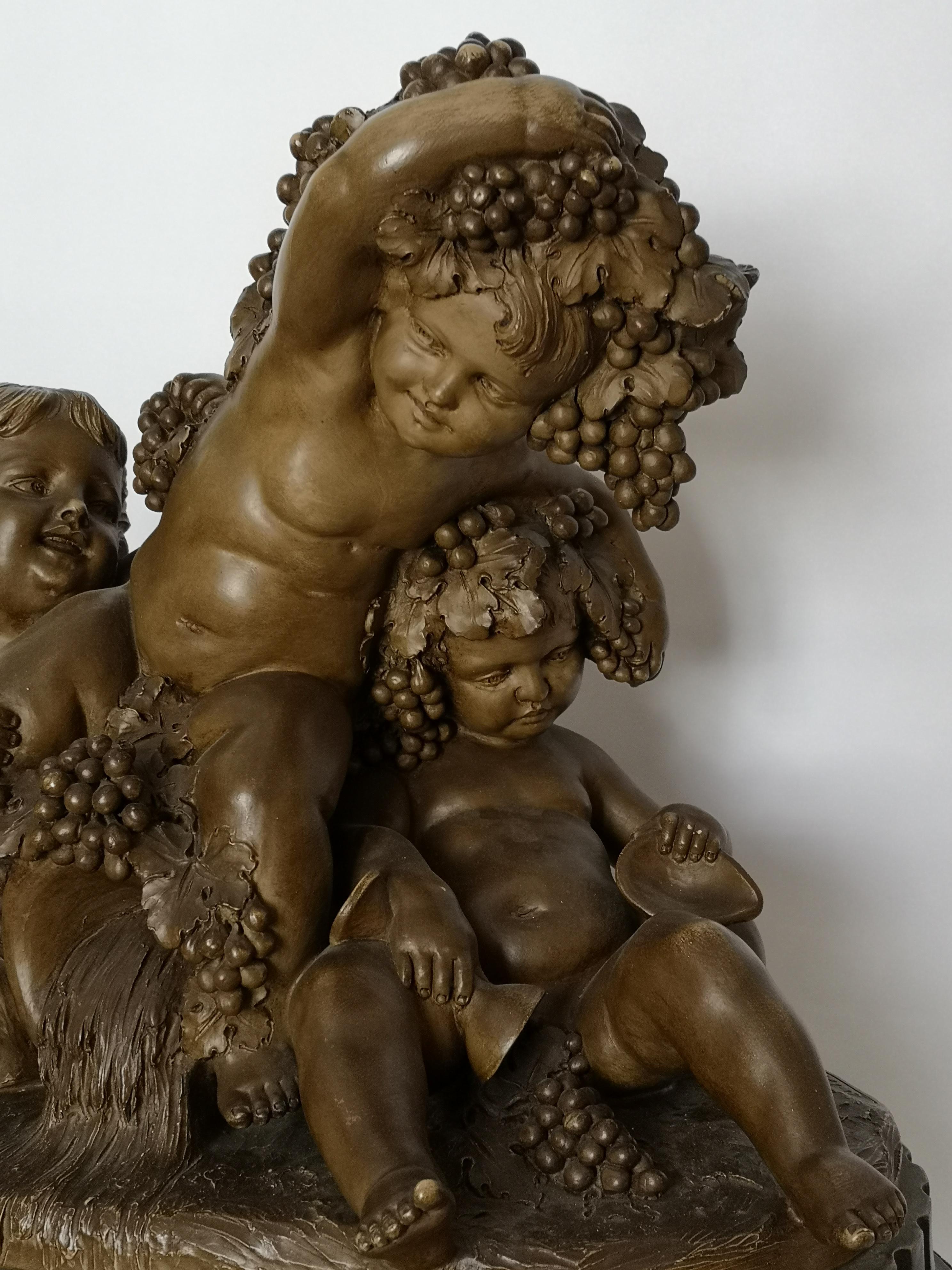 This large 19th century French terracotta group shows three young putti, one slumped back with a goblet spilling grapes depicting wine. The others look more joyful and are both holding grape vines. In the centre there's an amphora gushing out water,