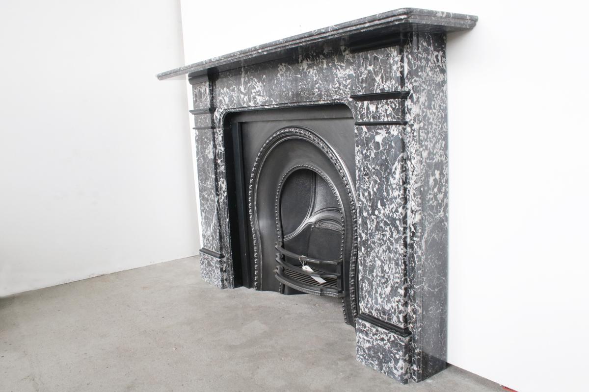 Large late Victorian St Anne marble chimneypiece with fluted capitals and Belgian black marble decoration, circa 1890.


St Anne marble was quarried in Belgium and this example shows some small areas of Pyrite (fools gold) to the top of the