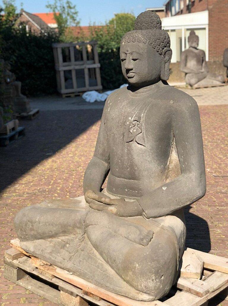 This antique lavastone Buddha statue is a truly unique and special collectible piece. Standing at 143 cm high, 112 cm wide and 73 cm deep, it is made of lavastone, a volcanic rock known for its durability and unique texture. The statue depicts the