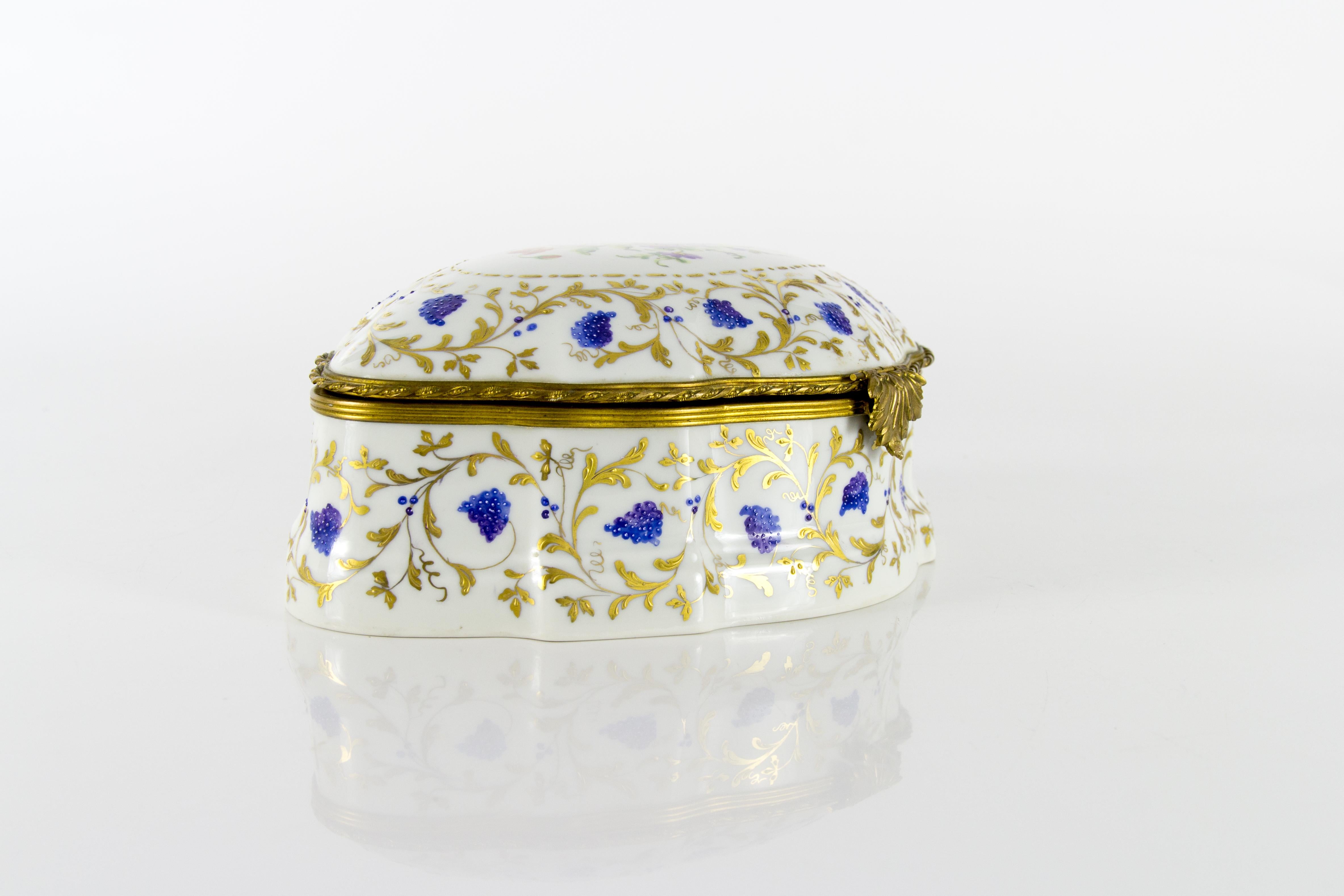 A large and gorgeous 1973 Atelier Camille Le Tallec hand painted porcelain trinket / jewelry box with ormolu brass mount. 
The marks on the bottom read “Dessiné et peint entièrement peint à la main par Le Tallec à Paris France, 