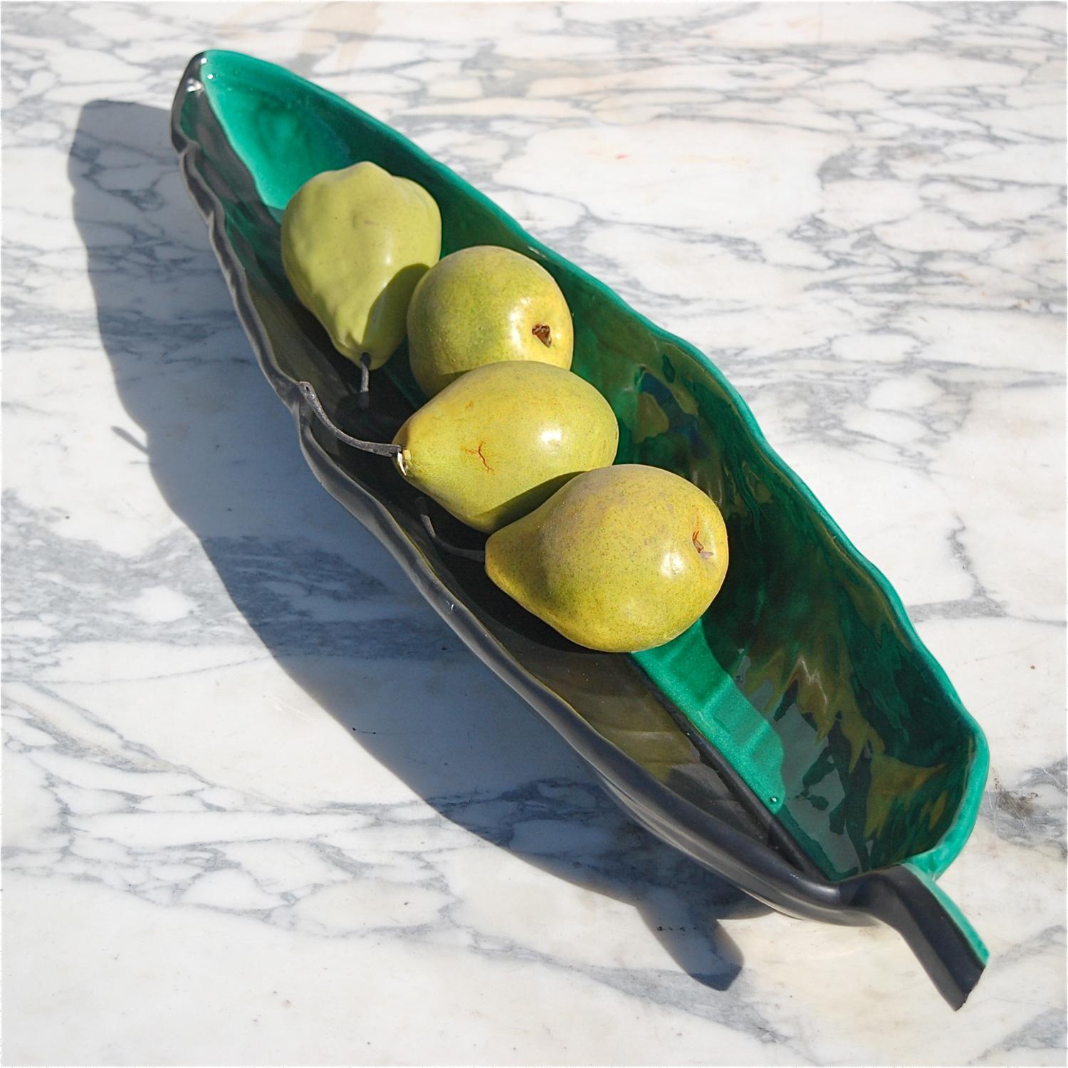 Large, elongated dish, bowl or tray in the shape of a large leaf. The stand out feature is the combination of a matt black finish on one half and a gloss green glaze on the other half. Hand formed, organic in shape and made in Vallauris. This world