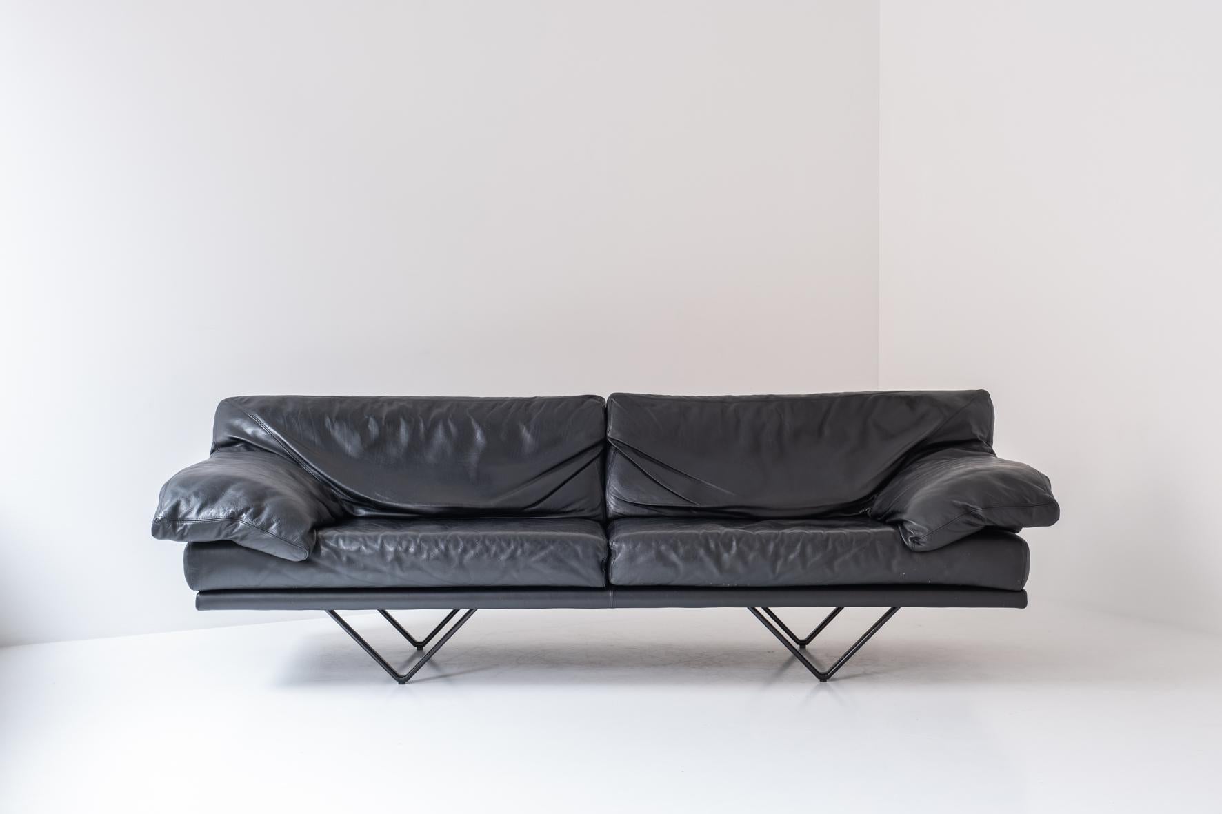 Large 3-seater, model ‘Cornelius’ by Durlet, Belgium 1980s. This sofa has a black lacquered triangle shaped base and features the original black leather upholstery. Well presented condition. Labeled inside.