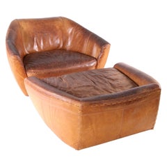 Grande poltrona e pouf in pelle