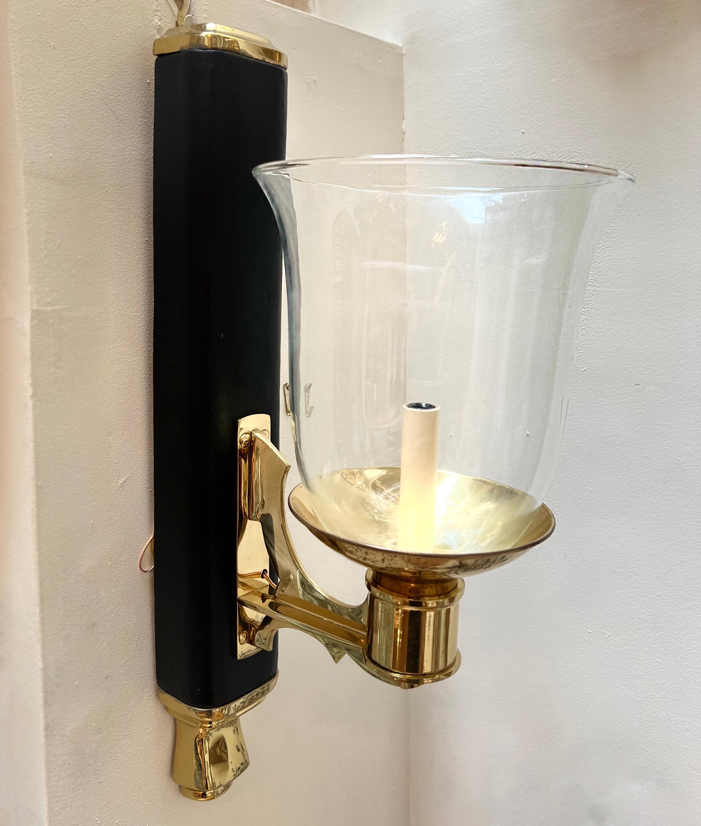 Pair of Italian 1960s leather and bronze sconces with glass hurricanes.

Measurements:
Height: 23.5