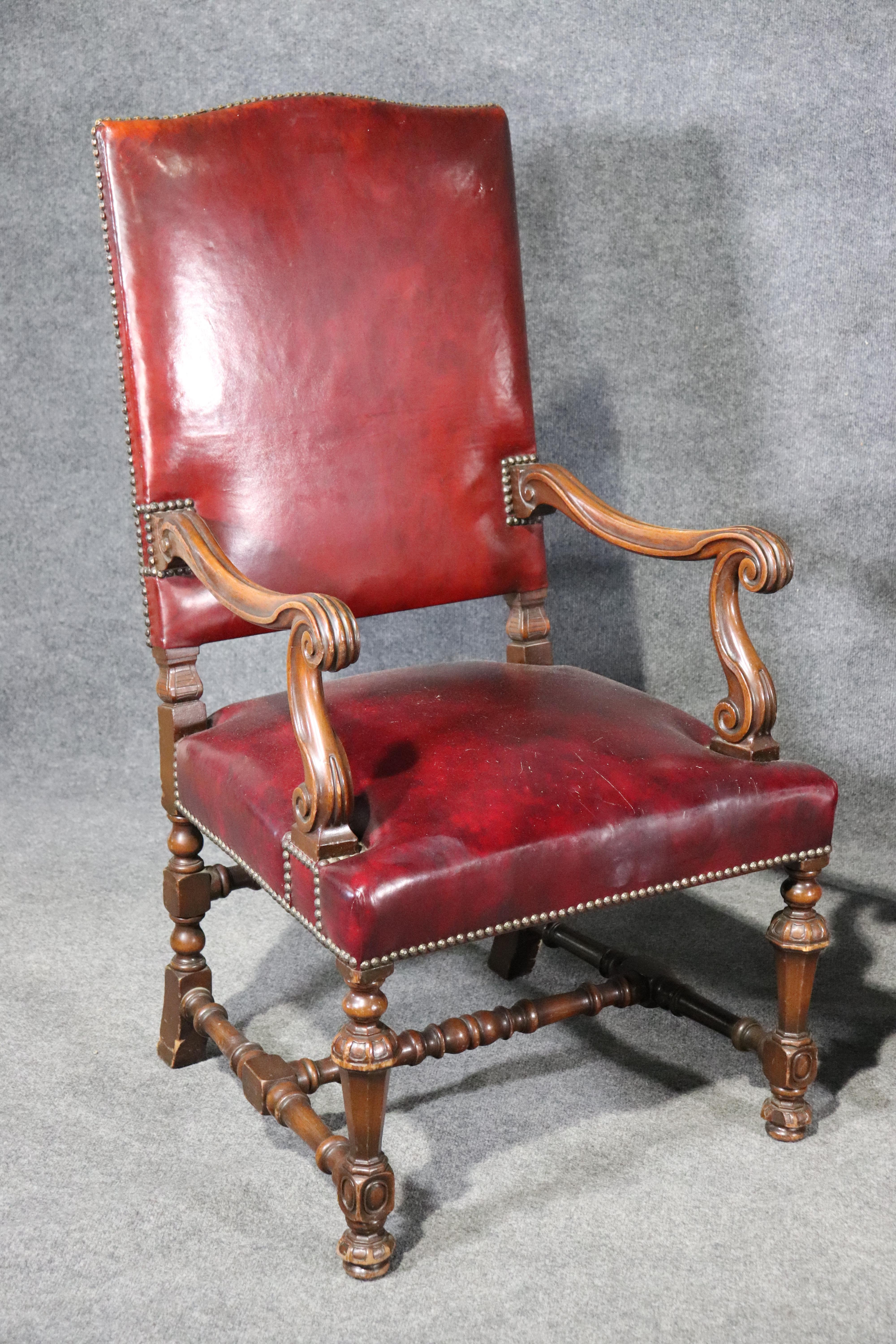 This is a gorgeous pair of distressed burgundy leather chairs that must have belong to a judge's chamber or perhaps a mayor's office. Look at the brass placques with the names and dates on the back. They are in good antique condition and have a