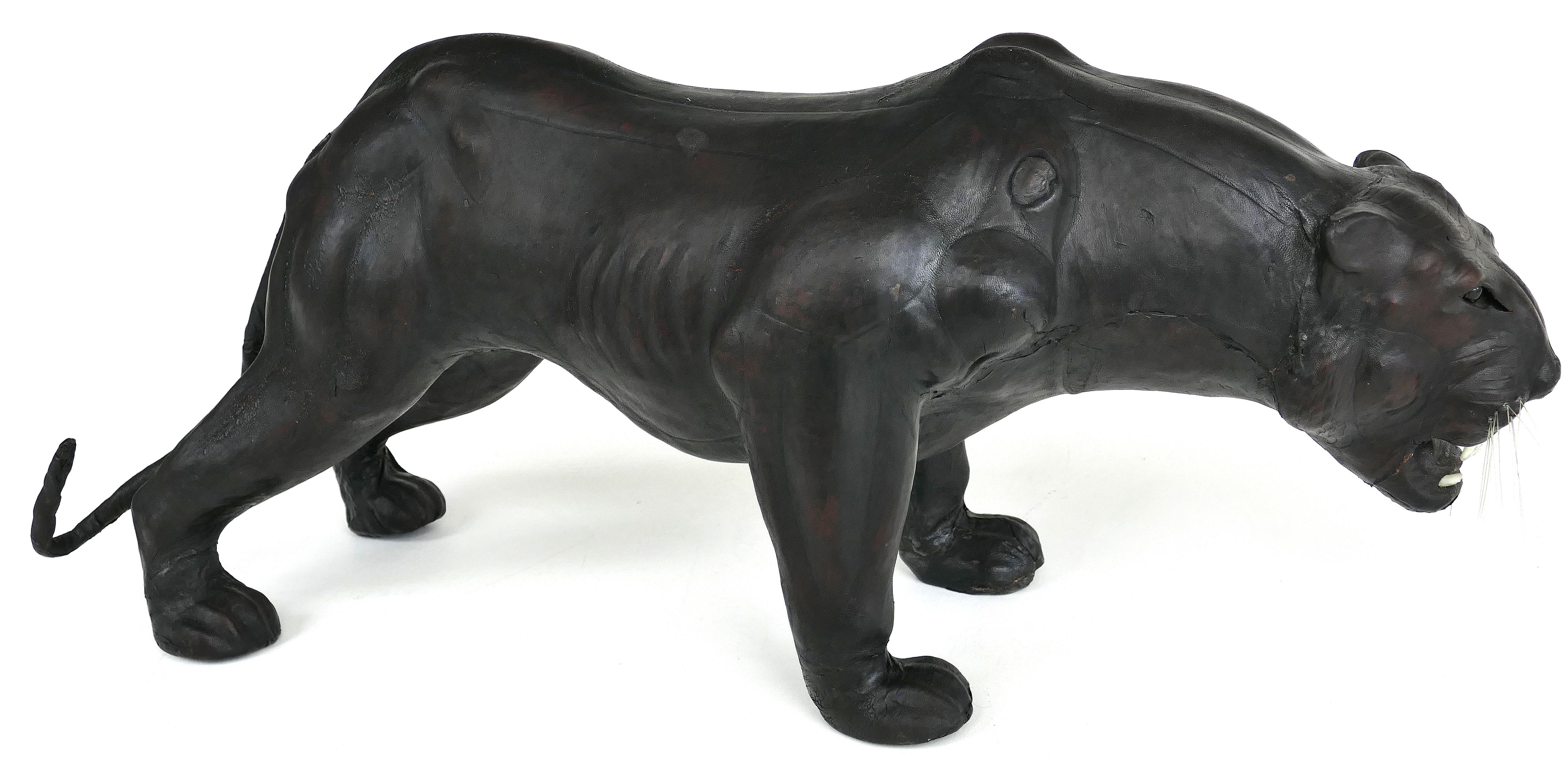 Large leather-clad sculpture of a Black Panther with glass eyes

Offered for is a large leather clad sculpture of a black panther with glass eyes. This large and imposing sculpture make a wonderful decorative element. The teeth and whiskers are