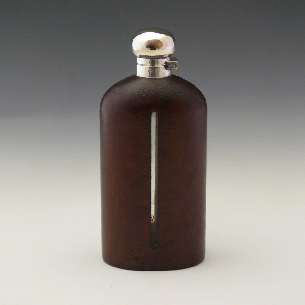 A fine pig skin leather covered glass hip flask with silver plated top of generous size.

Dimensions 23 cm/9 inches (height) x 10 cm/4 inches (width)

Bentleys are Members of LAPADA, the London and Provincial Antique Dealers Association.