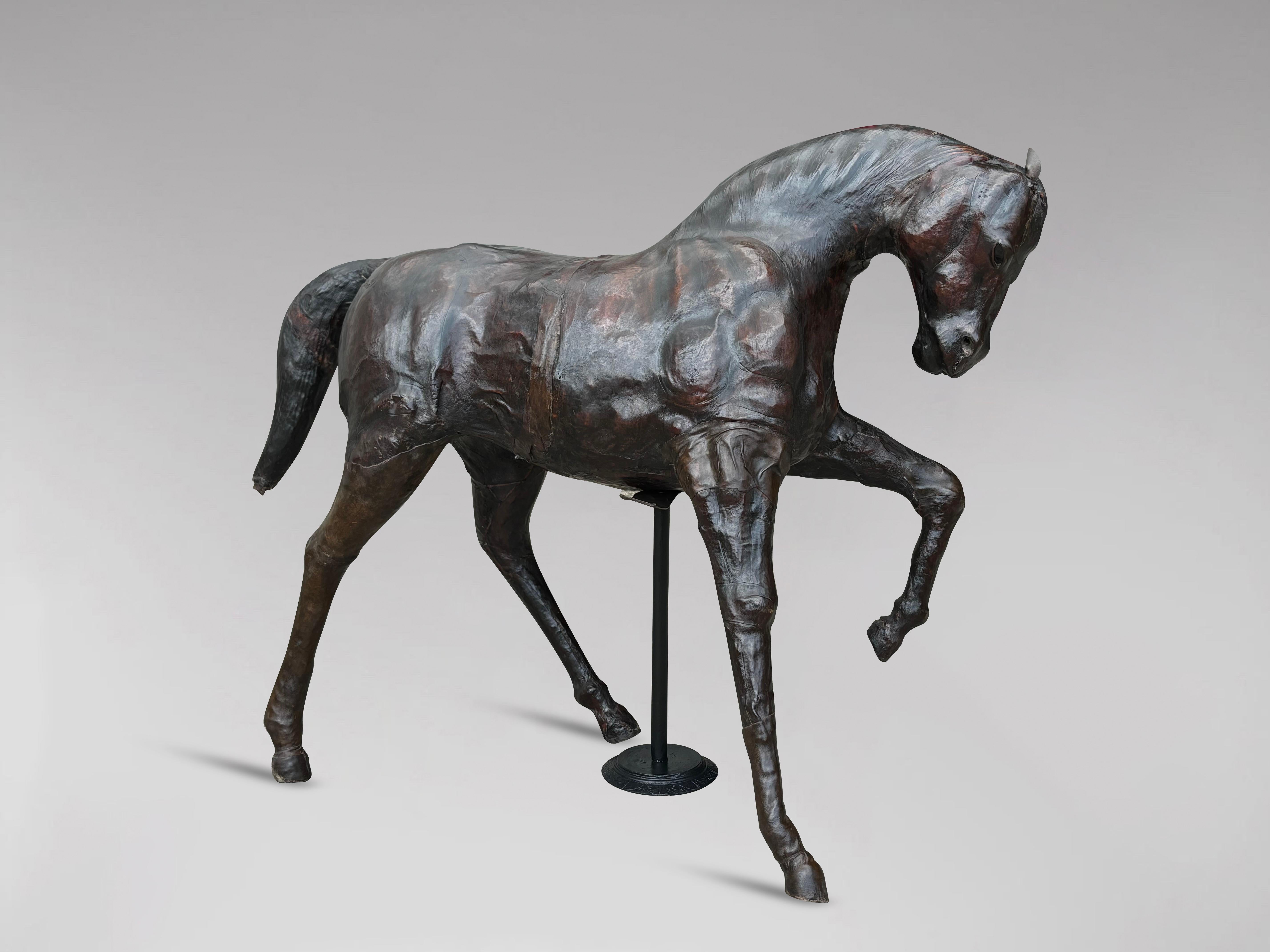 This impressive leather-covered horse sculpture, attributed to Liberty & Co of London circa 1930s, showcases exquisite craftsmanship and attention to detail. Stamped with 