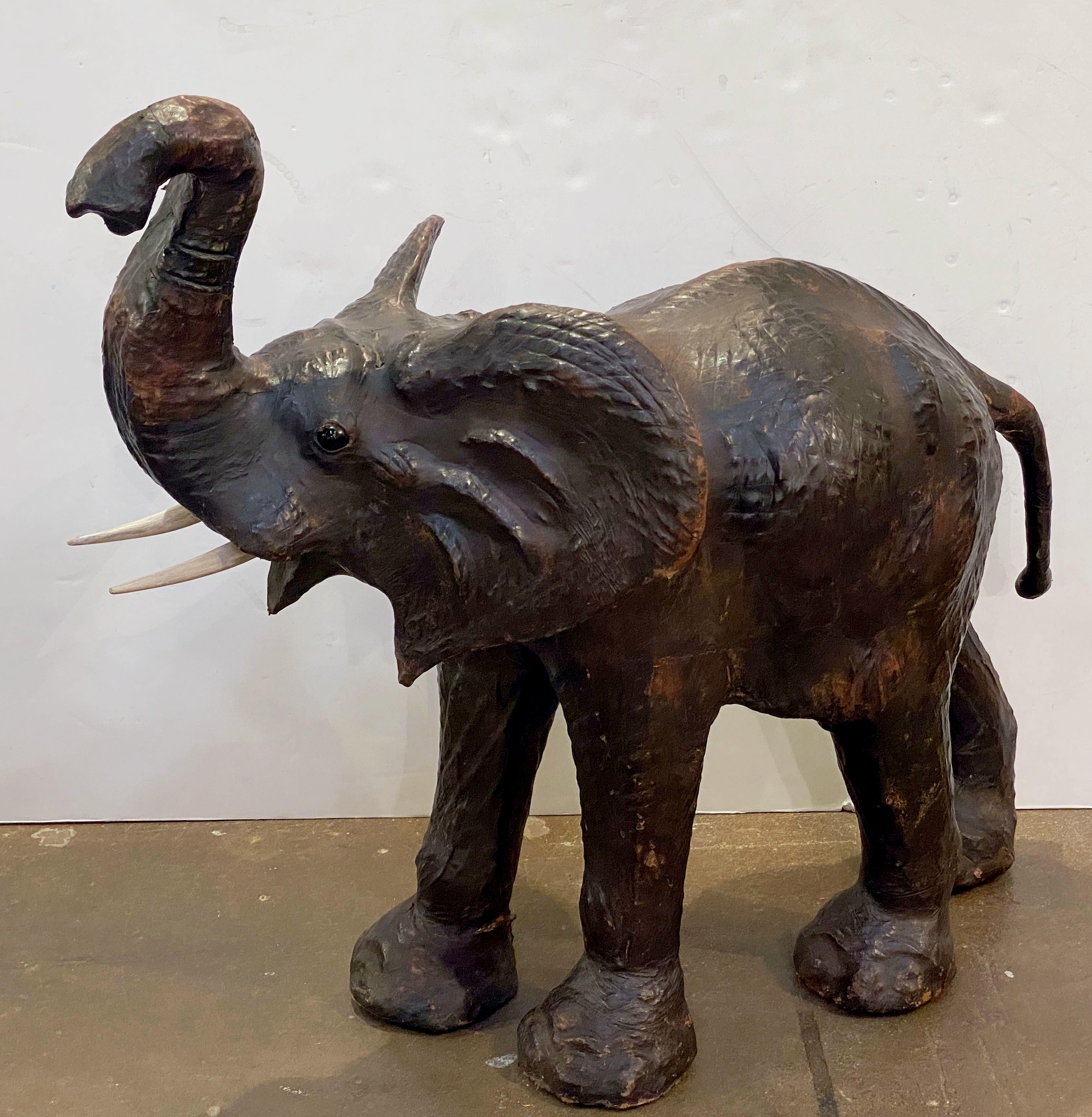 A fine large English model of a standing elephant from the early to mid-20th century, in cowhide leather with wooden tusks.

Dimensions are approximately: H 41 inches x W 47 inches x D 28 inches.