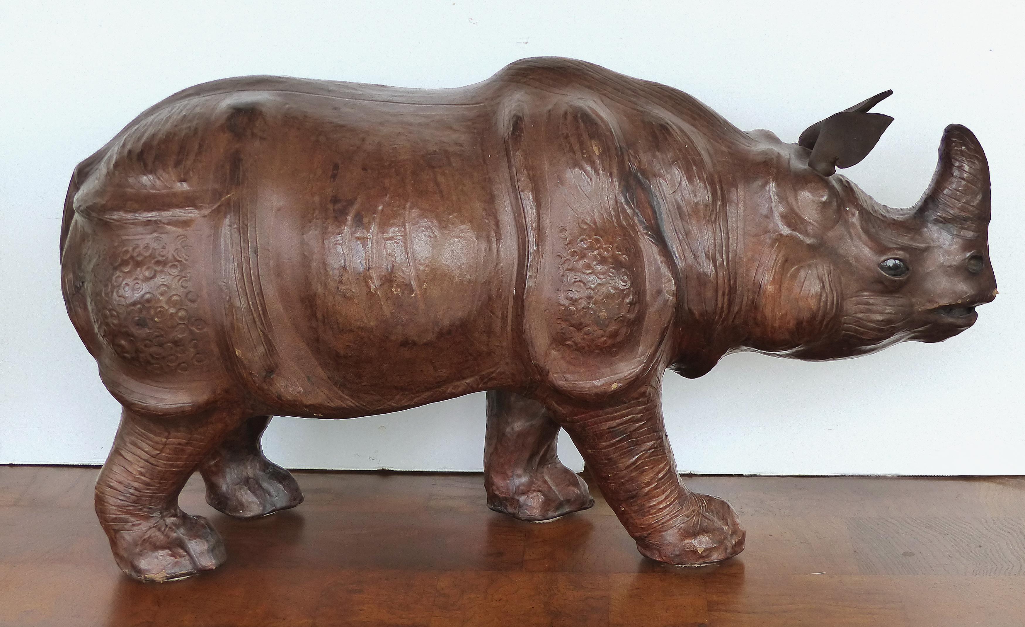 Large Leather Rhinoceros Sculpture with Glass Eyes

Offered for sale is a large and finely detailed leather clad sculpture of a rhinoceros. The rhinoceros has inset glass eyes and a leather tail and ears. The body of the rhino is tooled leather