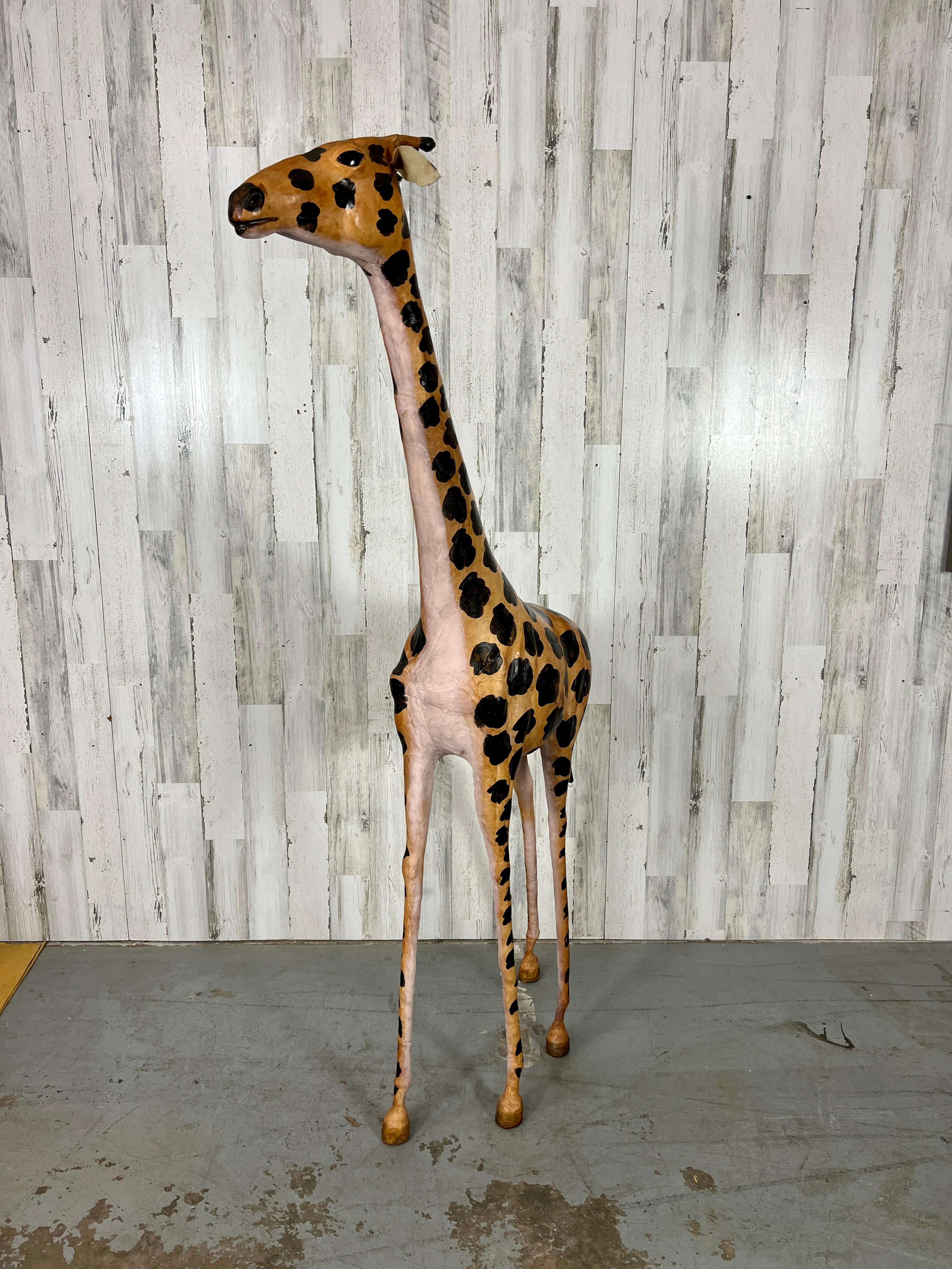 Extra Large hand crafted leather wrapped giraffe sculpture. intricate Hand wrapped leather with hand painted spots & details. Very rare to find one this tall! An extraordinary addition for the animal lovers home.  