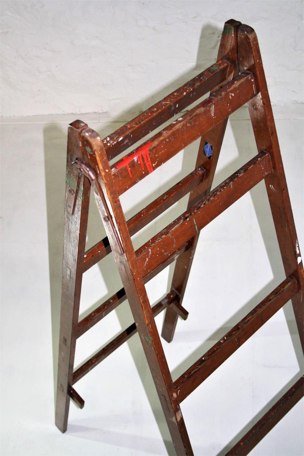 An imposing 1970 film prop ladder by maker Stephens & Carter, stamped L.F.S (London Film School). In good solid condition with nice wear and paint.
Originally designed and used as a lighting and camera holder, cross brasses are purposely built at