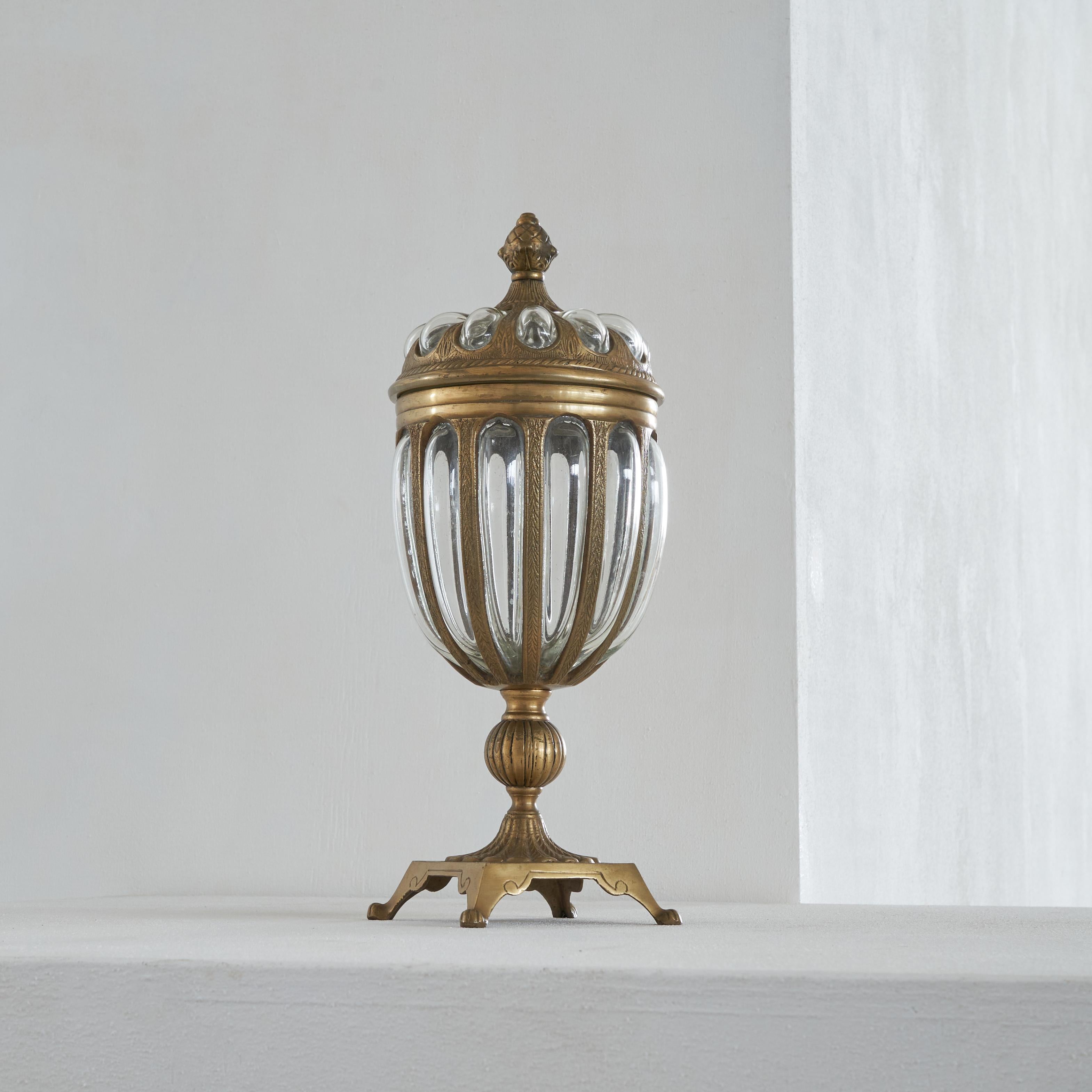 Large Lidded Apothecary Jar in Brass and Glass.

Very decorative large apothecary jar in patinated brass and hand blown bubble glass. Distinct piece. Wonderful decoration on every part and heavy quality. Great for display on a table, center table,